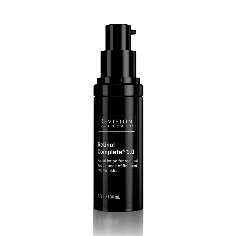 A black bottle of Revision Skincare Retinol Complete 1.0 facial lotion against a white background.
