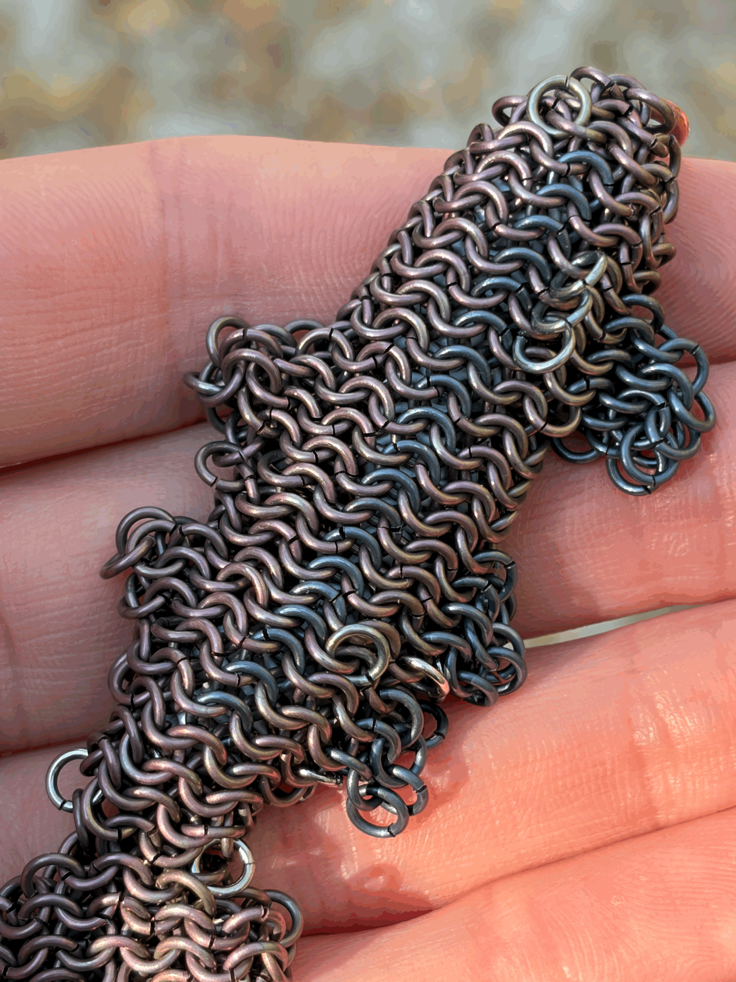 Close texture detail of woven anodized titanium structure in Titanium Trout sculpture — contemporary metal fish art