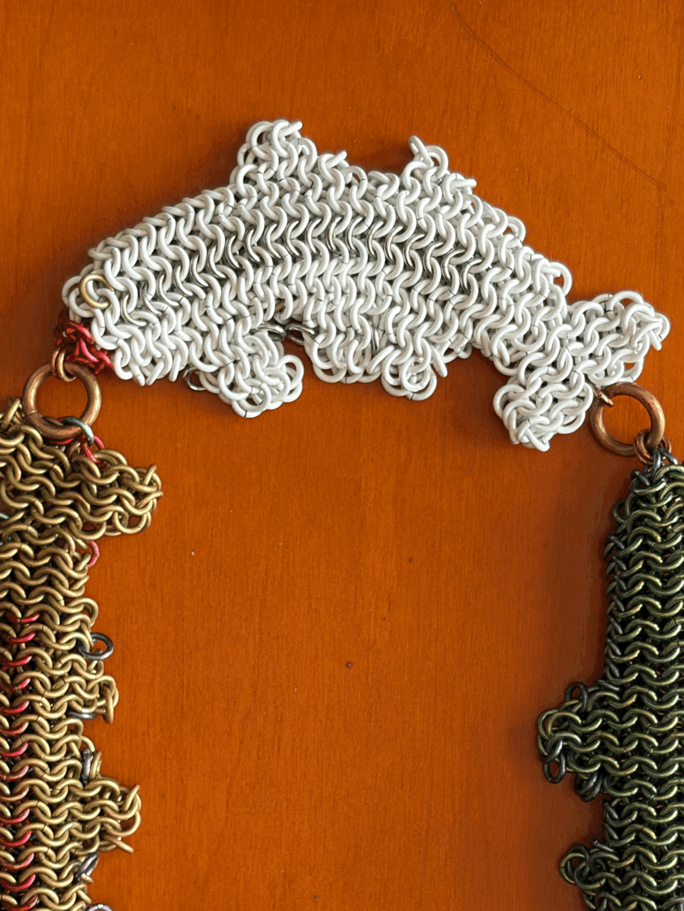 Close view of anodized niobium metal trout amulet surface texture in Dream Chain 01 sculpture — Litor Studio contemporary collectible