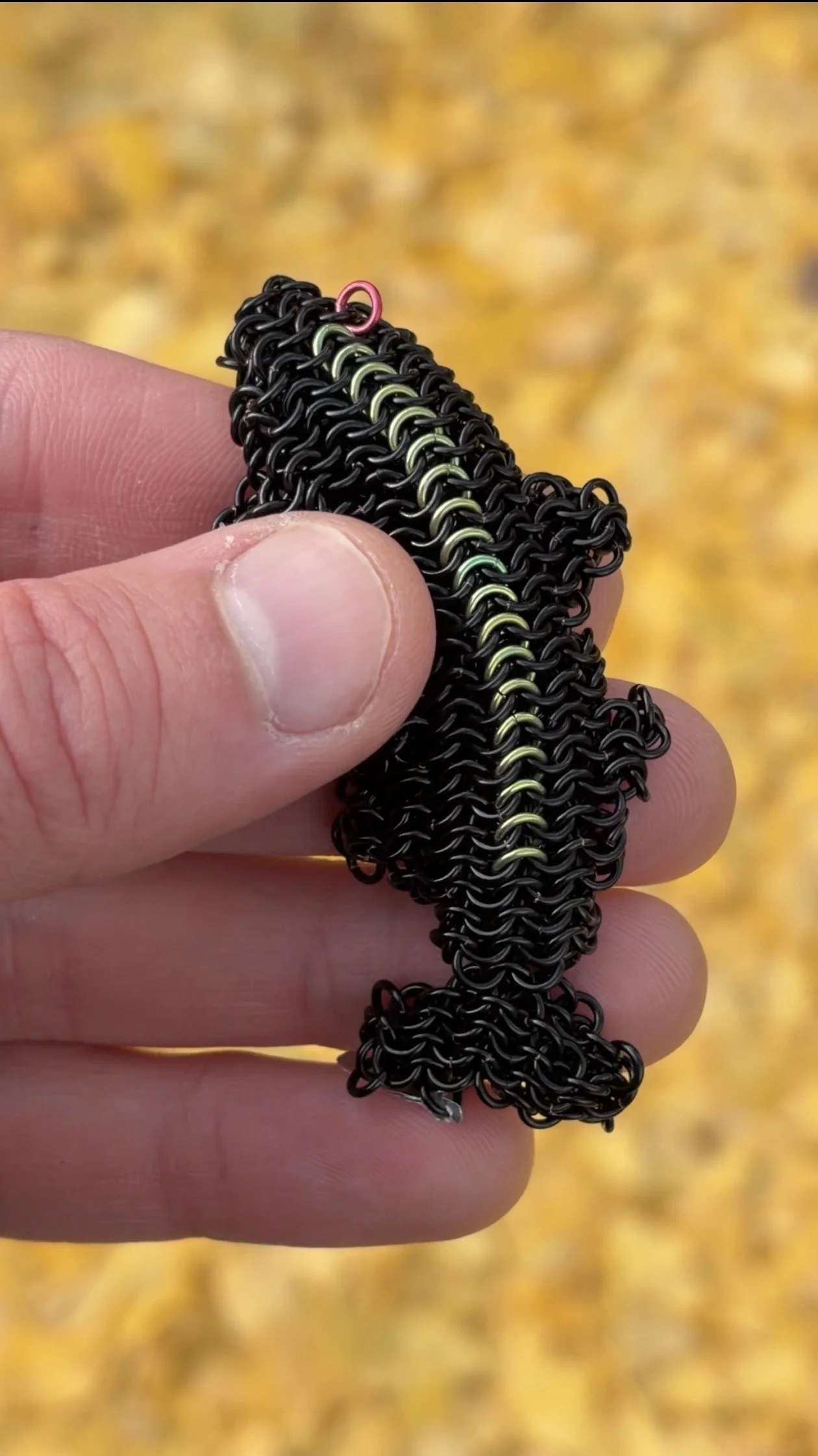 Ink Trout small metal trout sculpture in warm sunset light — enameled copper woven fish art object with niobium detail