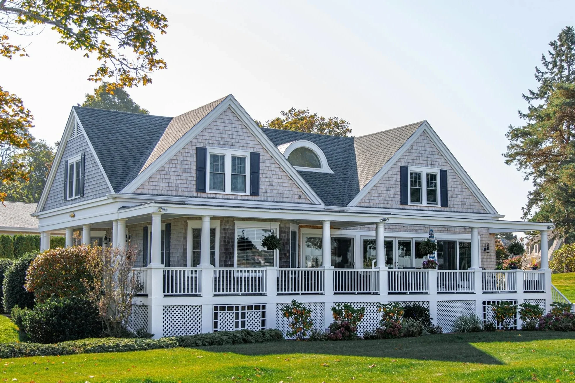 Two-story GTA home across Oakville, Burlington, Mississauga, and Milton with wraparound porch and lush landscaping