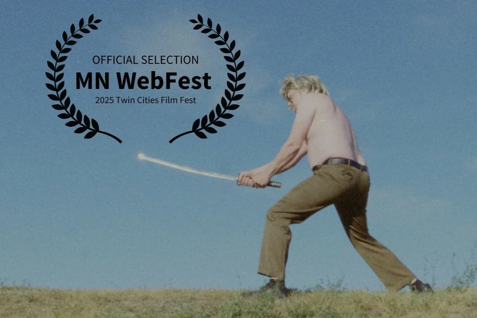 Scene from Renegade Fever showing man with a shirtless upper body, beige pants, and dark shoes standing on grass, holding a katana against blue sky. A black laurel indicates official selection MN WebFest 2025 Twin Cities Film Fest.