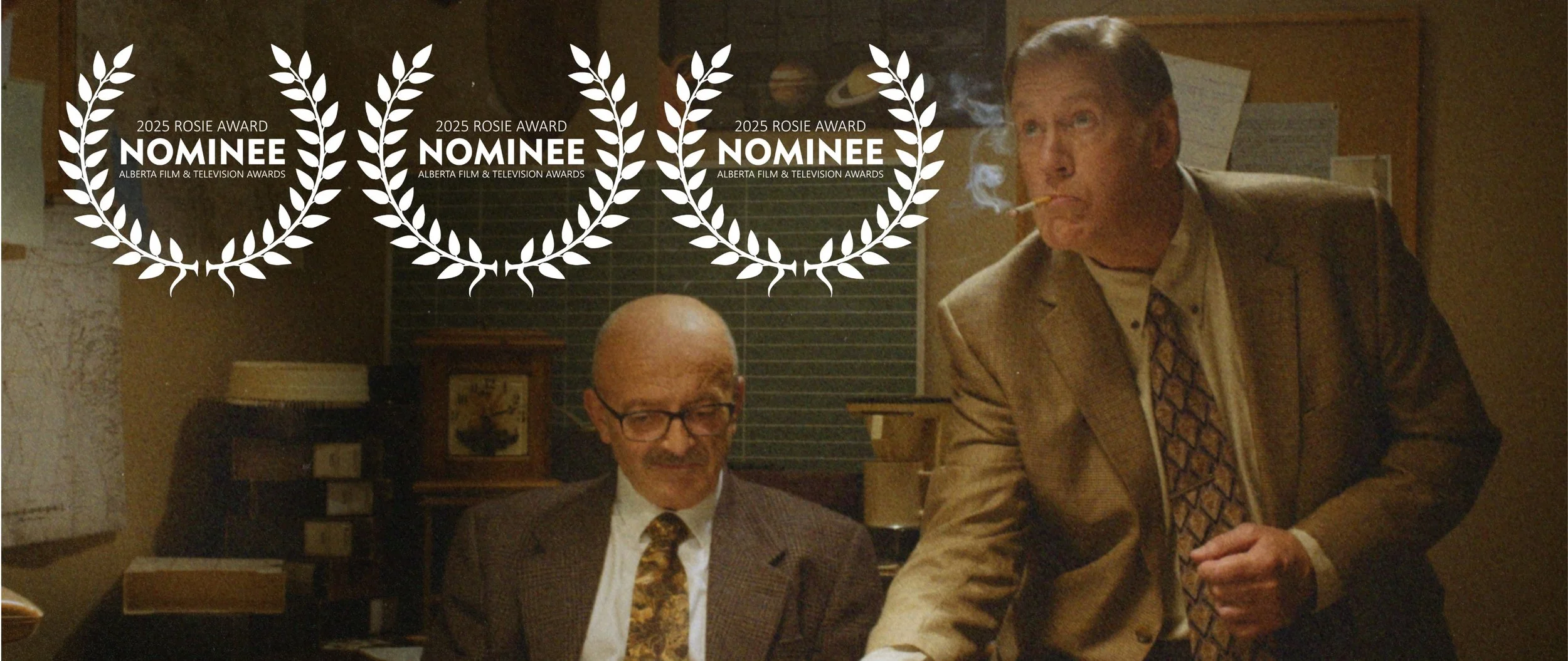 Scene from Renegade Fever showing two men in a dimly lit office. One is seated with glasses, the other is standing with a cigarette, smoking. Three laurels indicate Rosie Nominations for AMPIA 2025. 