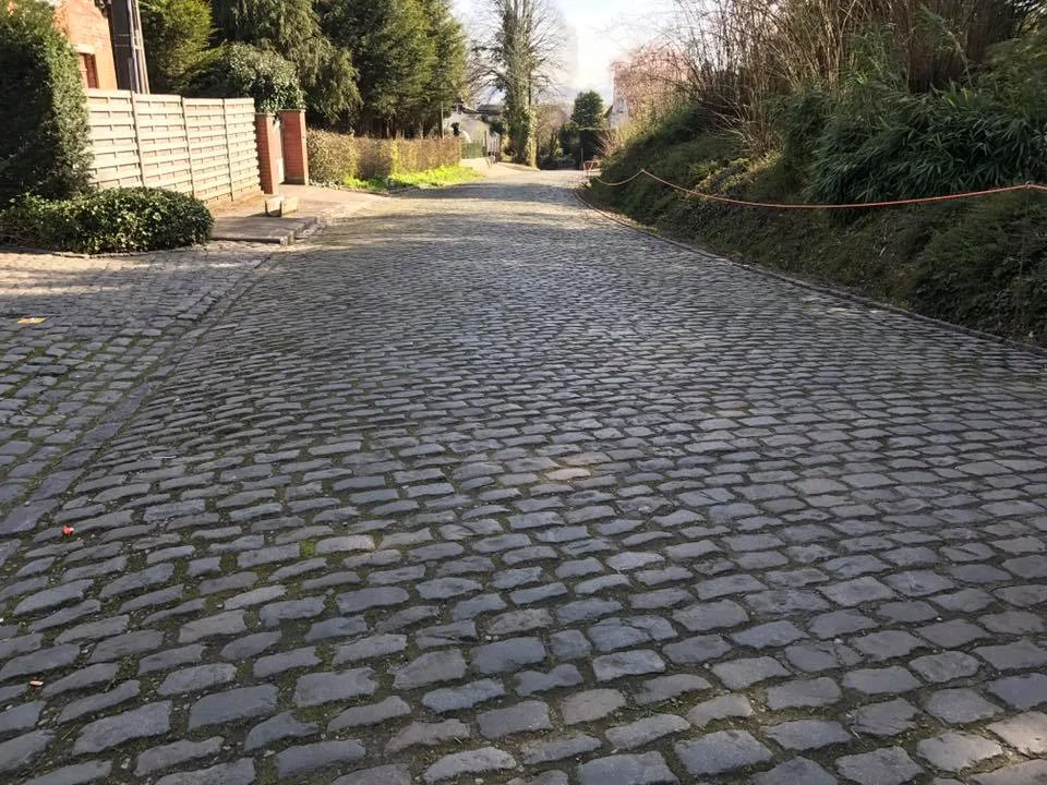 Not all sections of cobbles are equal, this section is more perfectly manicured although far from flat and perilous in the rain with roads narrowed by rabid fans.