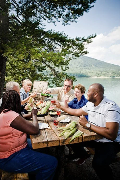 Older couples sitting together outdoors, smiling