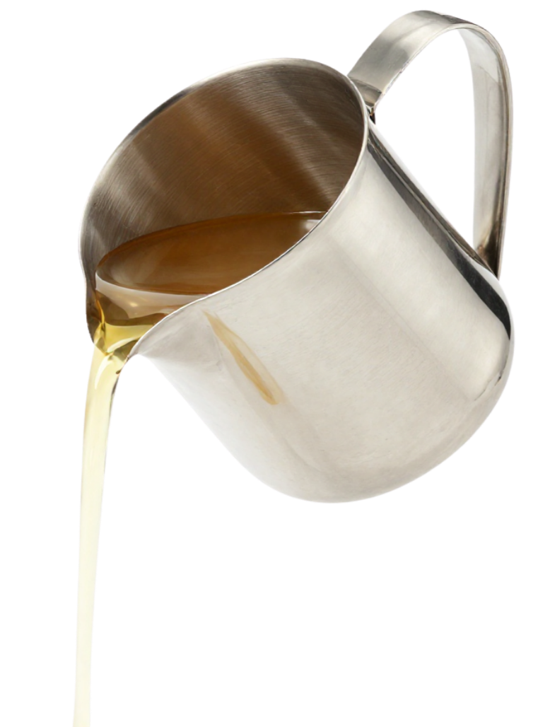 A metal pitcher pouring a dark liquid, possibly coffee, with some of the liquid sloshing out.
