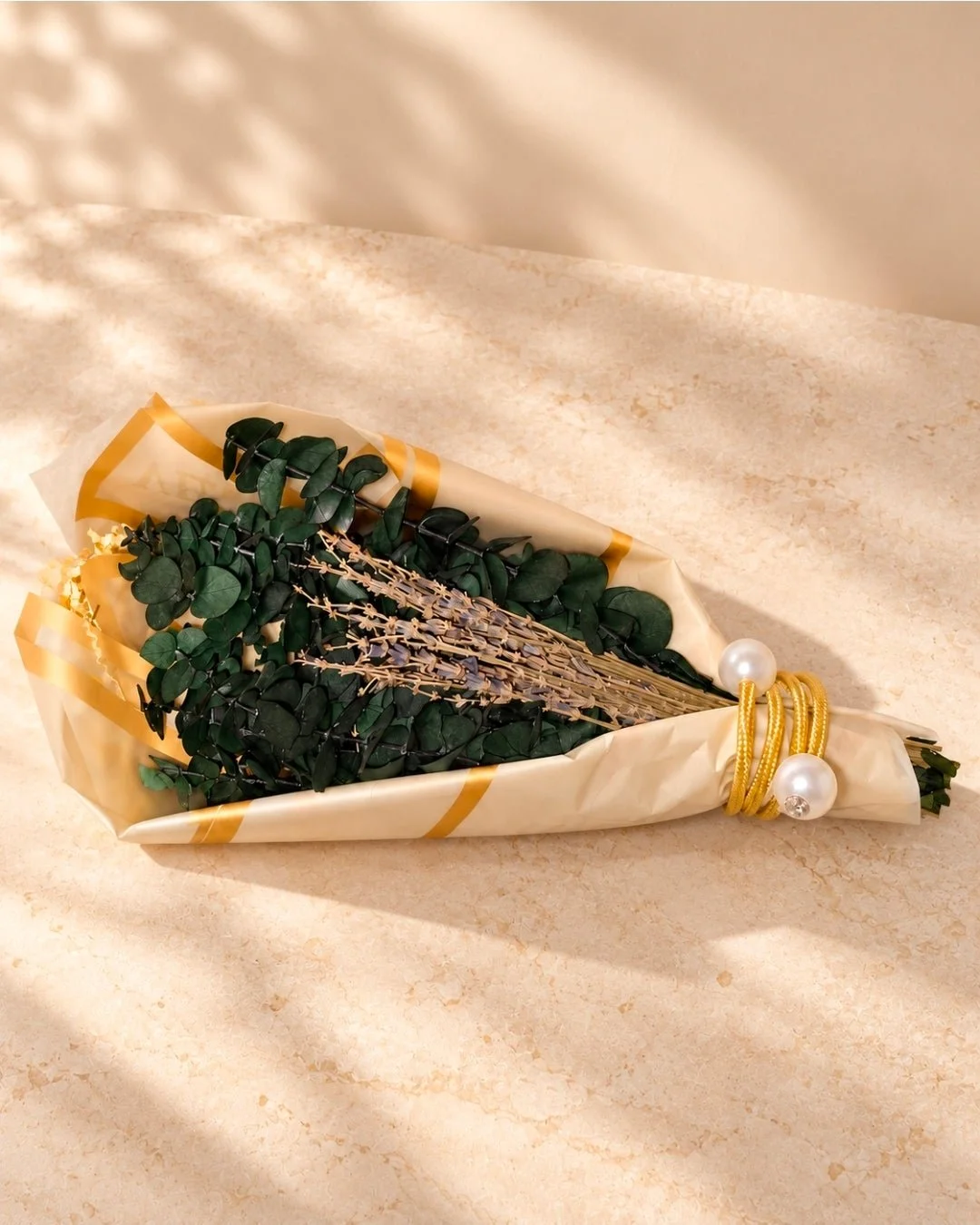 Velvet & Float eucalyptus and lavender Shower Bouquet in gold-edged wrapping with its adjustable gold hanging tie.
