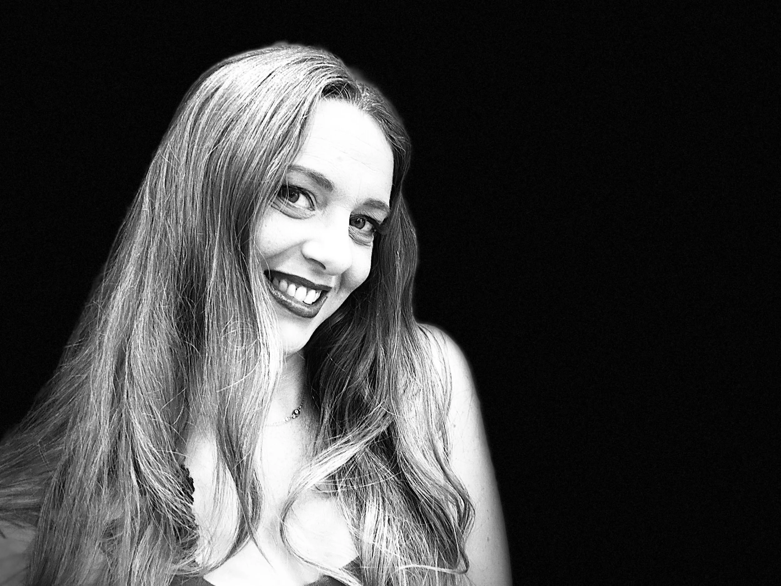 Black and white portrait in dramatic lighting of bb soto against black background.