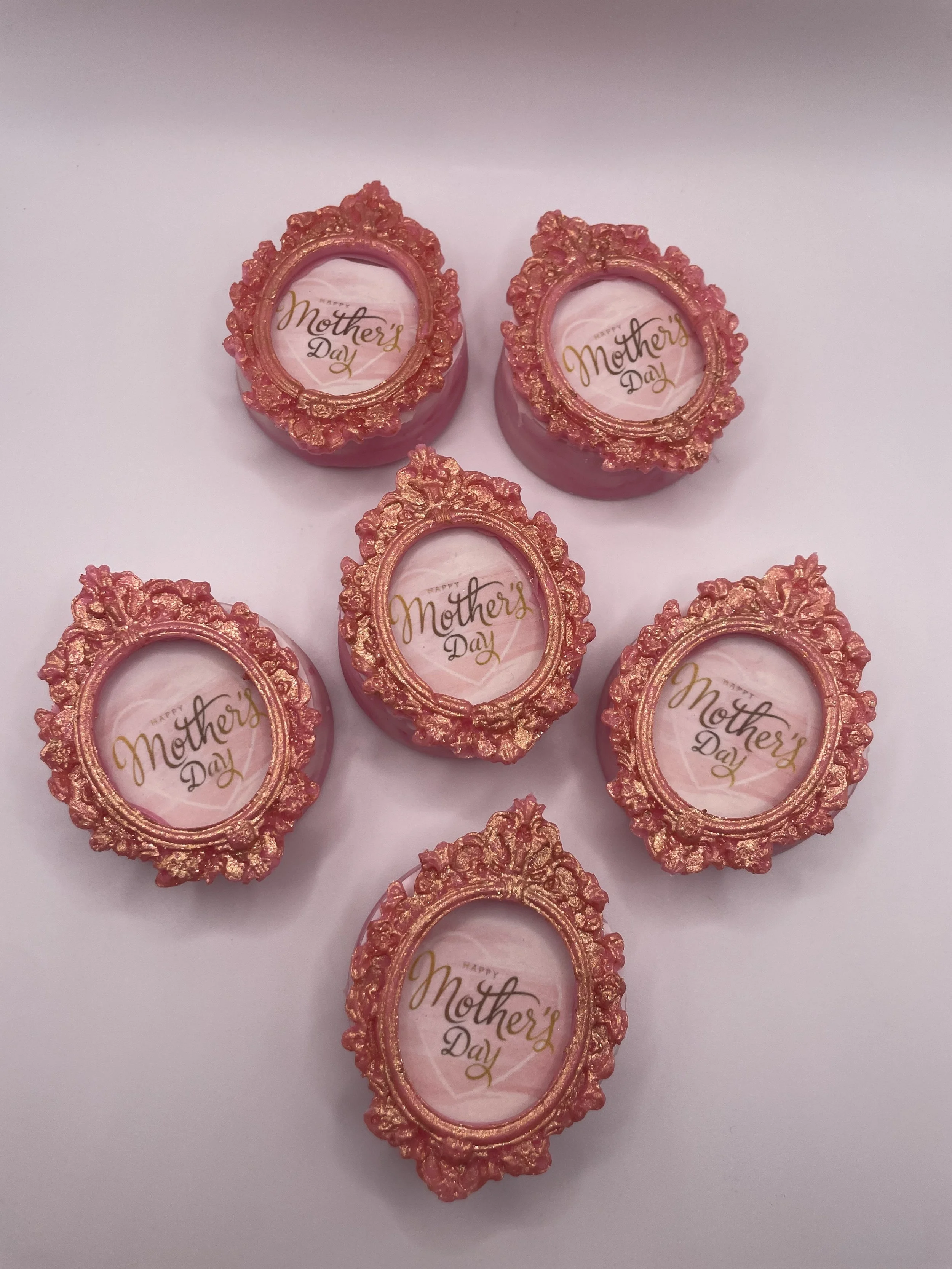Six decorative flower-shaped Mother's Day cards with pink and gold embellishments, each featuring a small oval window with 'Happy Mother’s Day' written inside.