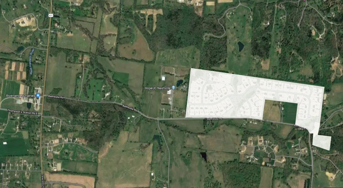 Satellite view of a rural area with roads, houses, and some bodies of water. A large, light-colored overlay marks a residential development site along Bethesda Road.