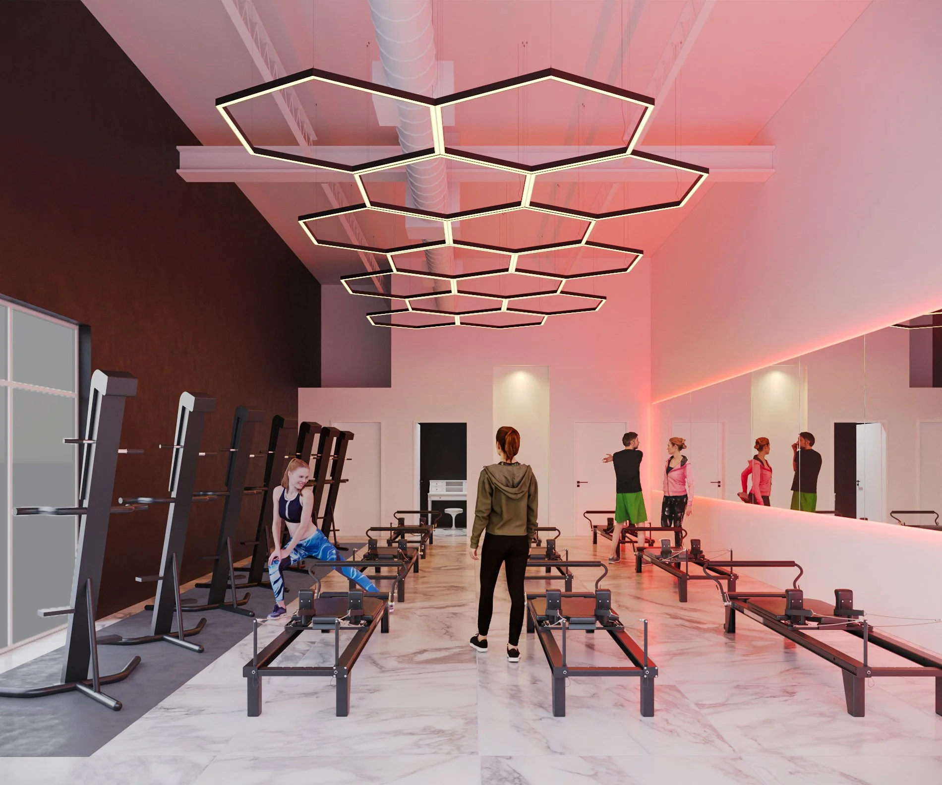 Modern fitness studio with mirrored wall, geometric ceiling lights, and reformer machines. People are exercising on machines, and racks are positioned along one wall.