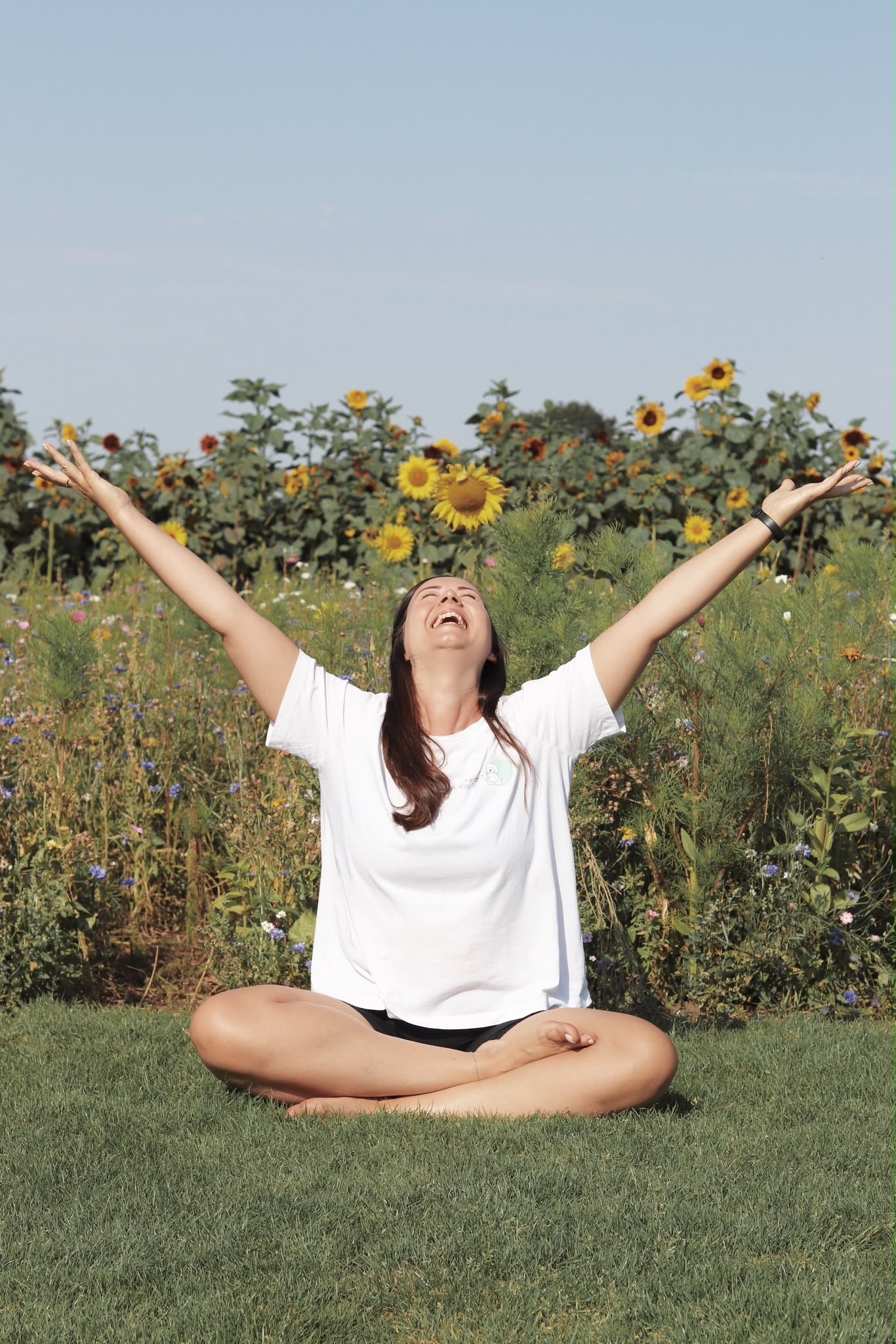 Hannah sunflowers arms up.JPG