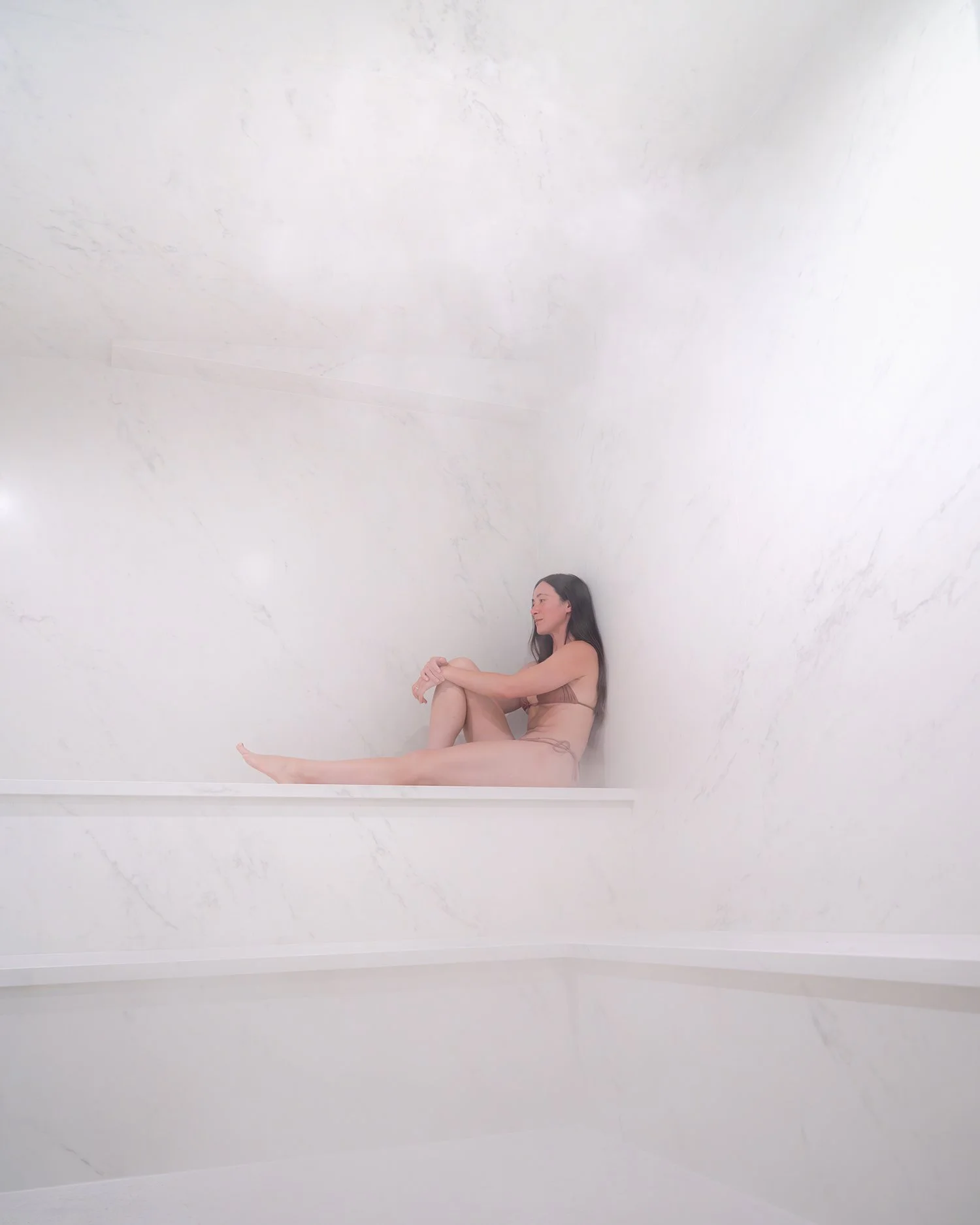 woman resting in steam room during sauna circuit at Loma Sauna House Oregon coast