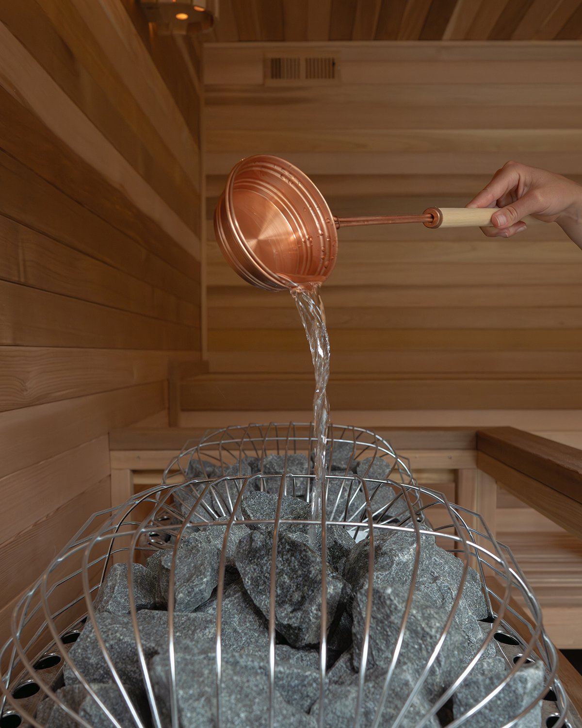 Cedar sauna pouring water