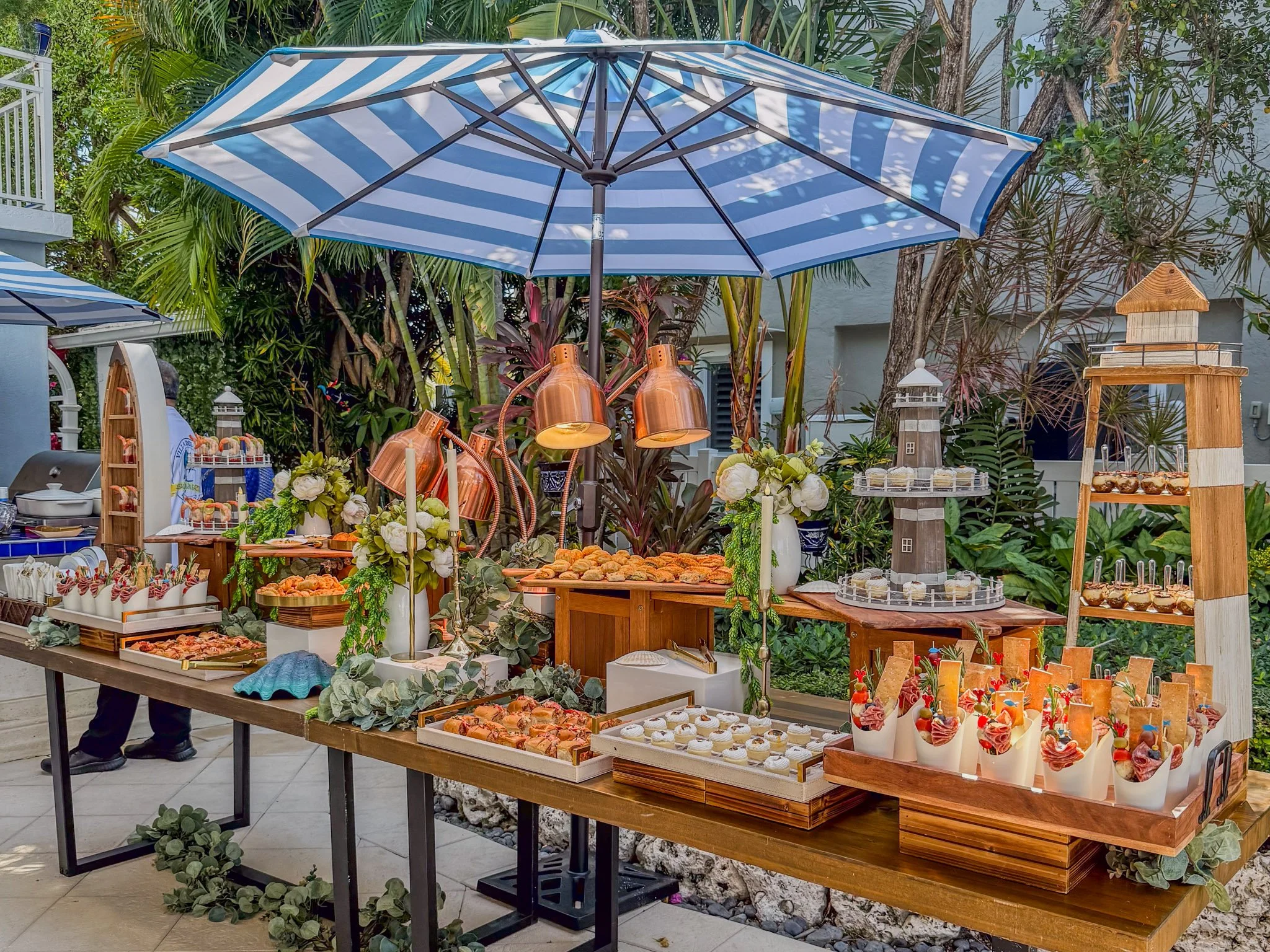 Luxury outdoor catering display by Francesca’s Catering in Miami featuring gourmet appetizers, floral décor and elegant garden styling.