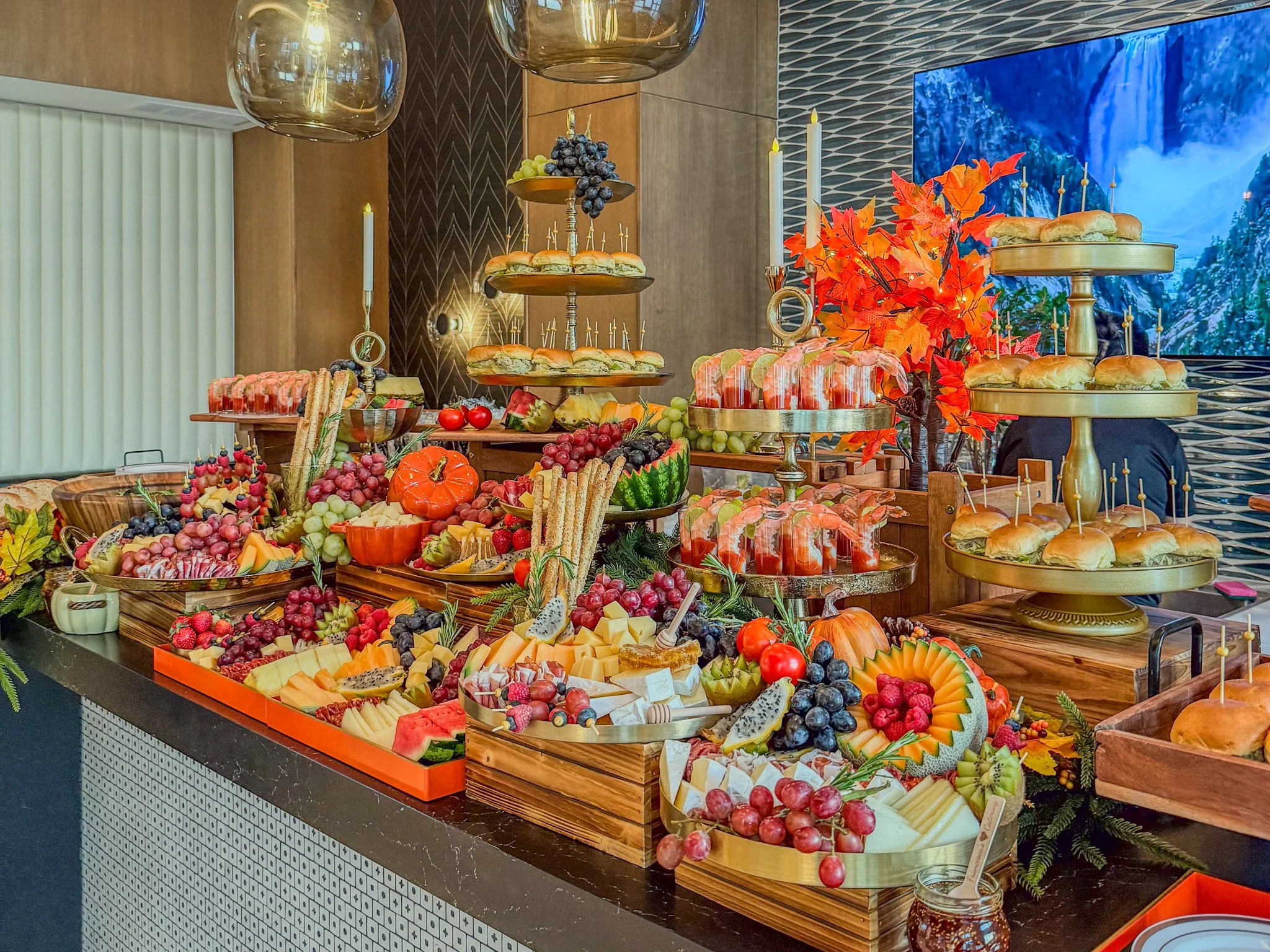 Luxury grazing table by Francesca’s Catering in Miami featuring sliders, charcuterie, fresh fruit displays and elegant event décor.