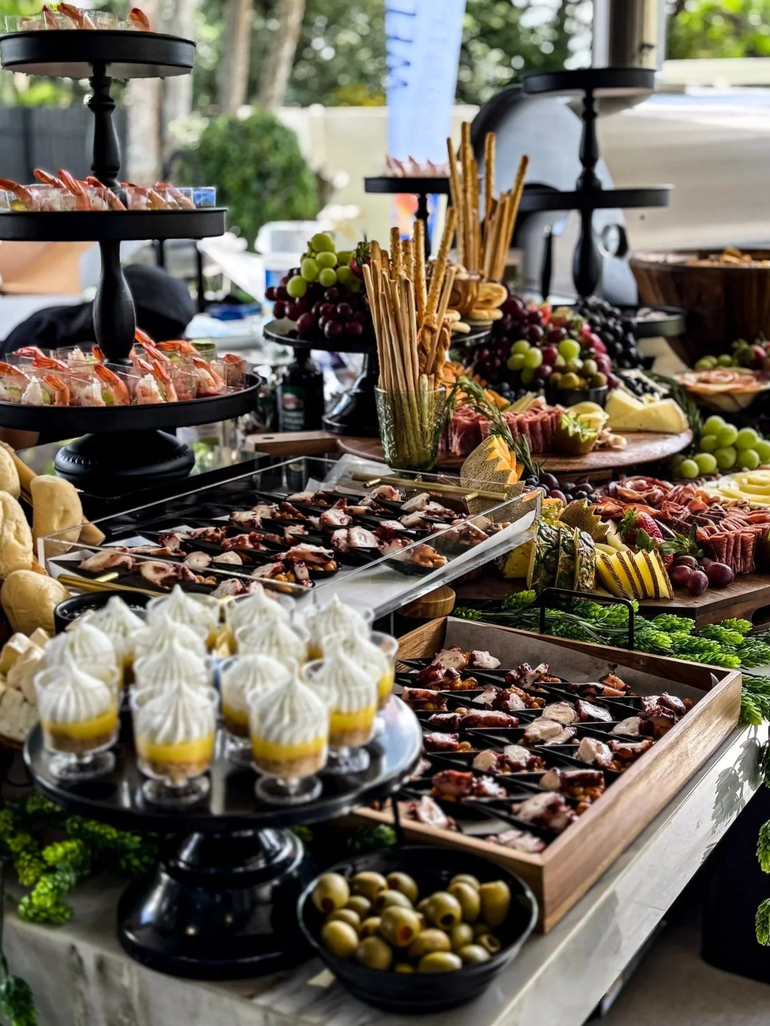 Luxury outdoor cocktail hour catering by Francesca’s Catering in Miami featuring gourmet appetizers, charcuterie and elegant grazing table display.