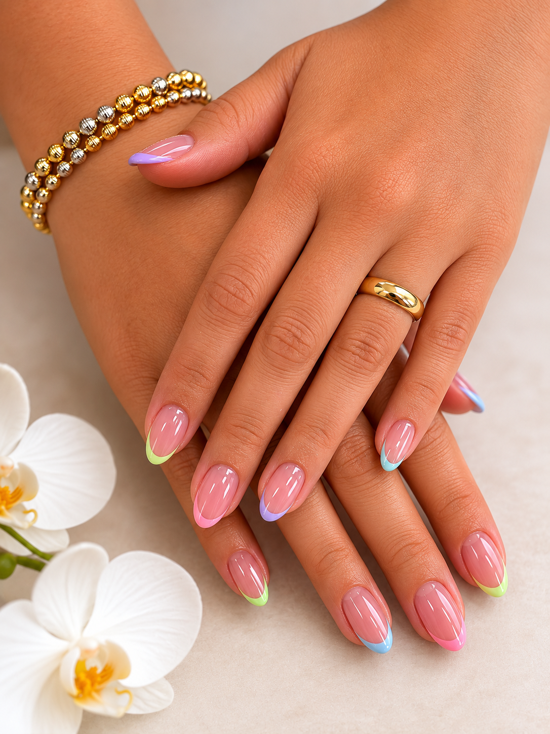 Pastel French tip manicure featuring colourful neon tips on almond-shaped nails