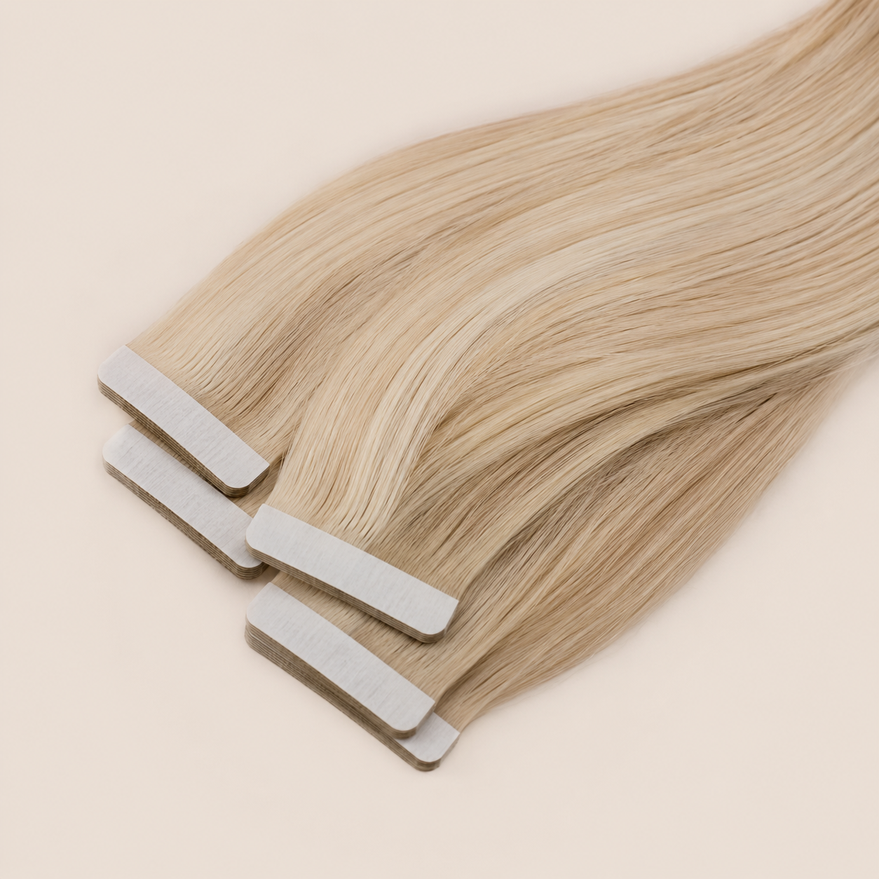 Premium tape hair extensions in blonde human hair for natural volume and length at Glam & Go Salon Dubai.