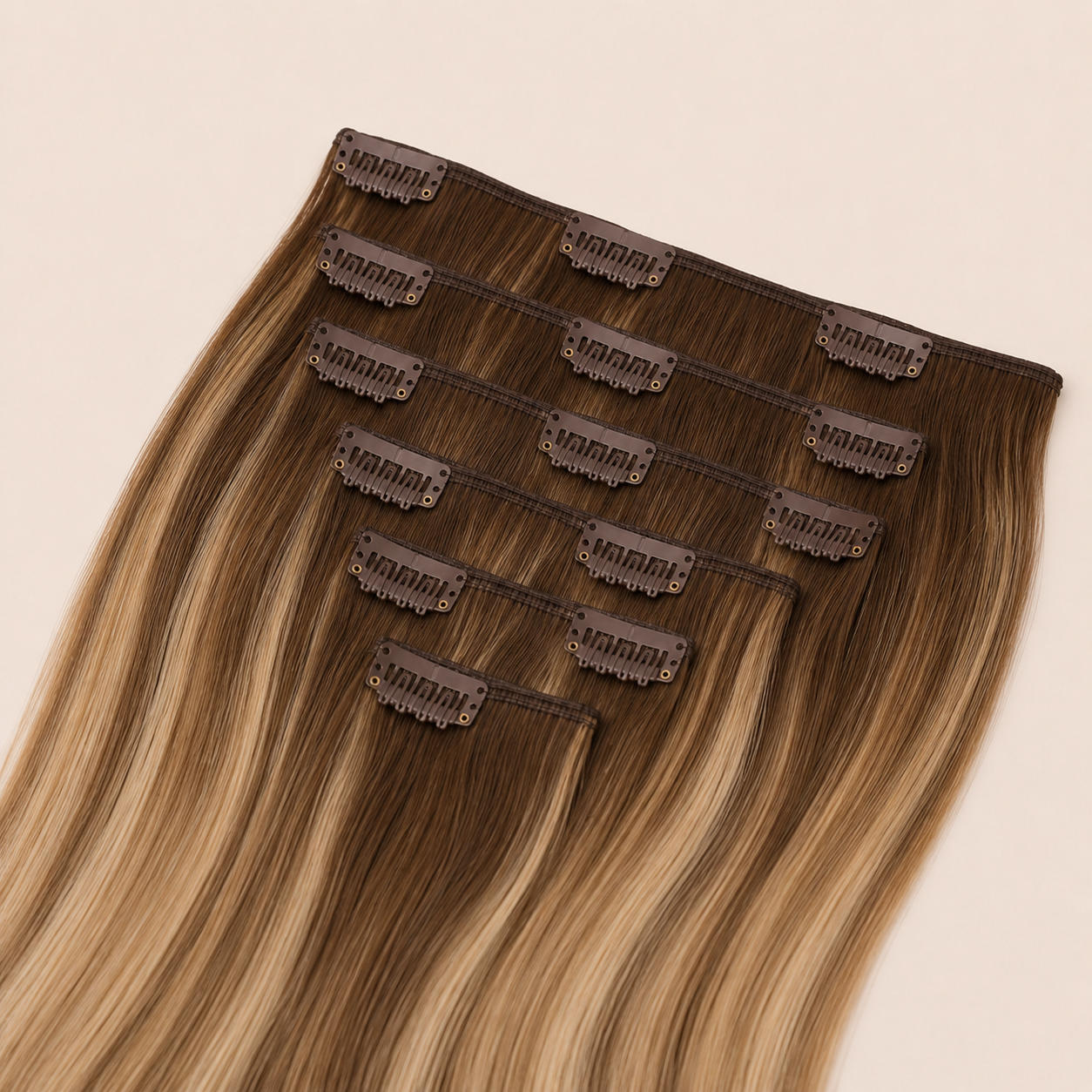 Premium clip-in hair extensions in warm caramel balayage human hair for temporary volume and length at Glam & Go Salon Dubai.