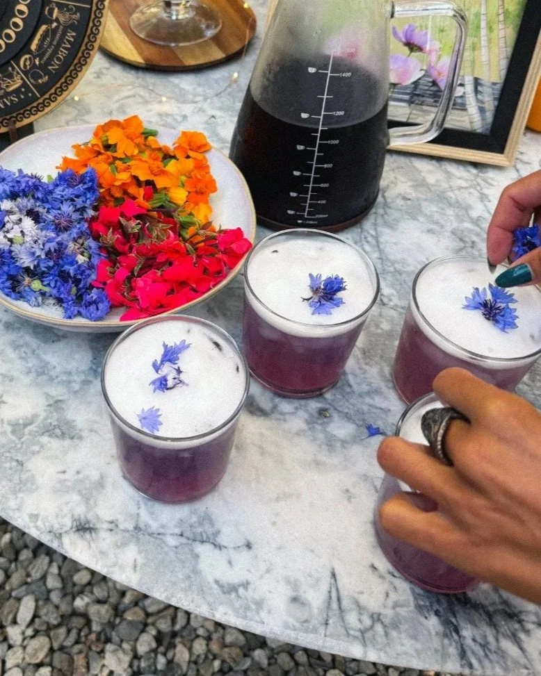 Single guests get a bachelor's button (for alchemical wayfinding) and mocktails get bright fun flowers. 