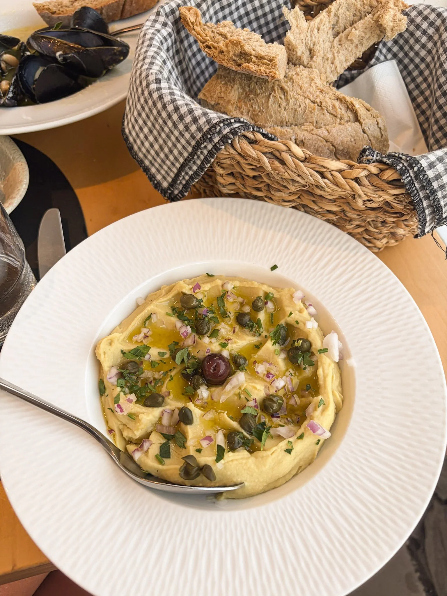 I've never found authentic Greek fava at any restaurant outside of Greece. The pureed yellow split peas come from Santorini and is served warm. You read that right, there's no fava beans in it! Over time Greeks transitioned to an easier legume to pre