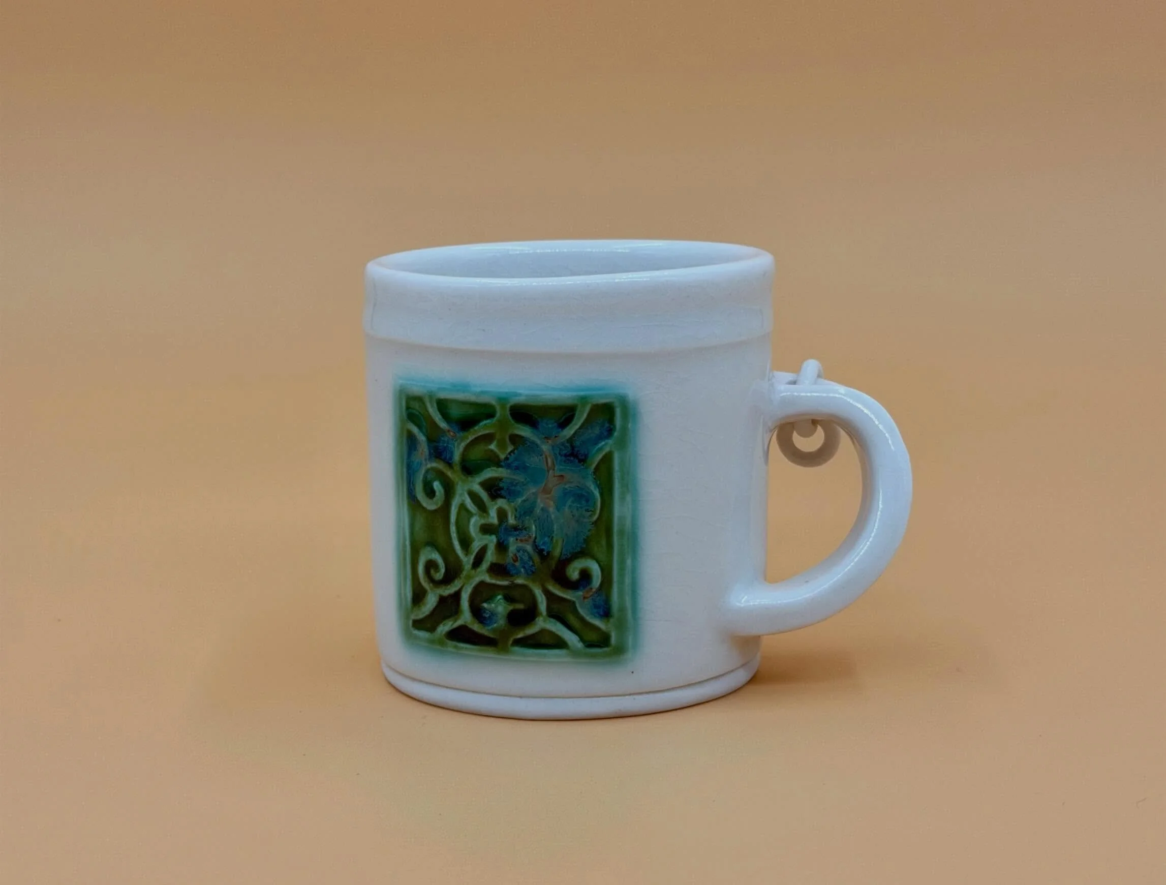 fidget mug

this farewell gift for a talented friend (@naomi_ceramiclanterns) who has moved on from my studio references ironwork patterning and the most intricate designs that she carves into her masterful luminaries. i was also inspired by her to p