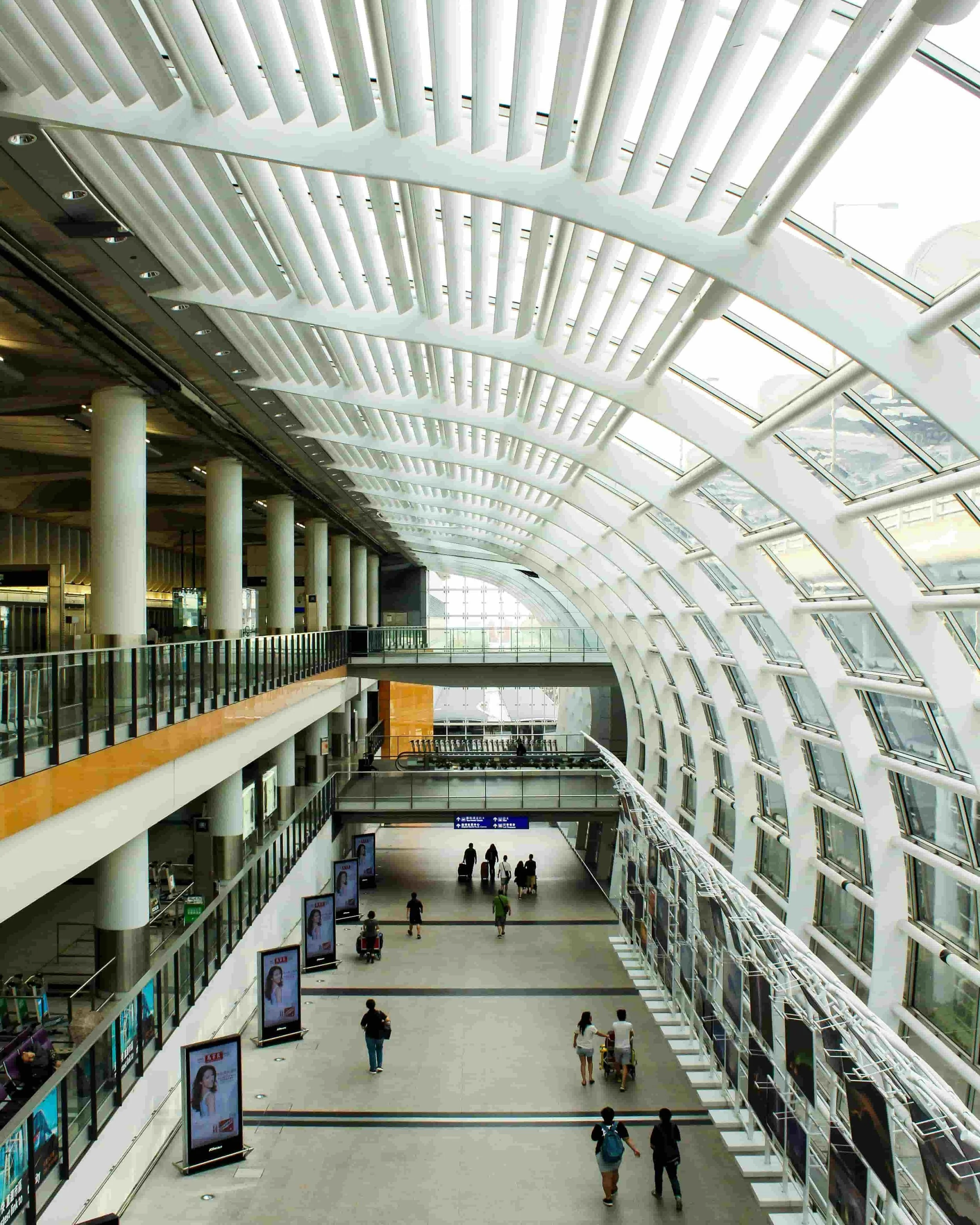 Modern airport terminal with travelers passing through on their way to their next destination.