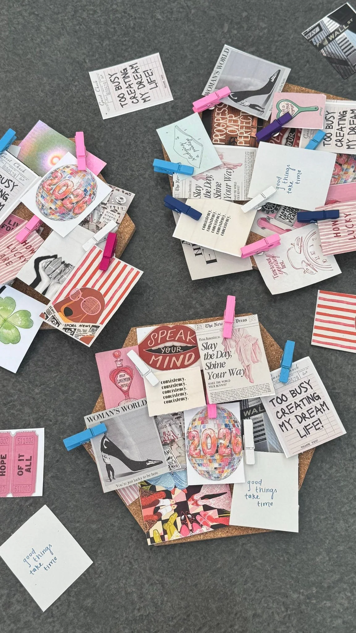 A corkboard with various small notes, pictures, and illustrations pinned with colorful clothespins, including messages about staying positive and taking time, and decorative images like a disco ball and high heel shoe.