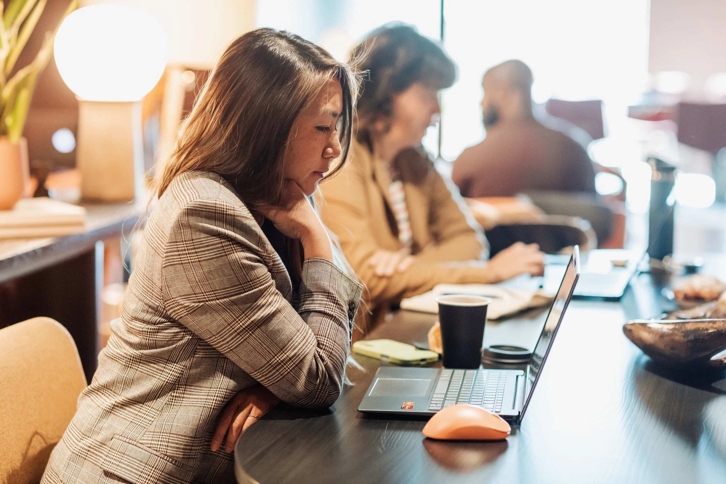 Solopreneur working at laptop in TARRA's coworking lounge