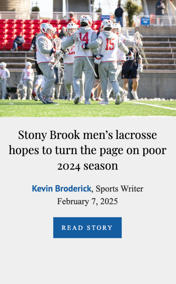 A group of lacrosse players in gray uniforms with red accents huddled on a field, celebrating or strategizing during a game.