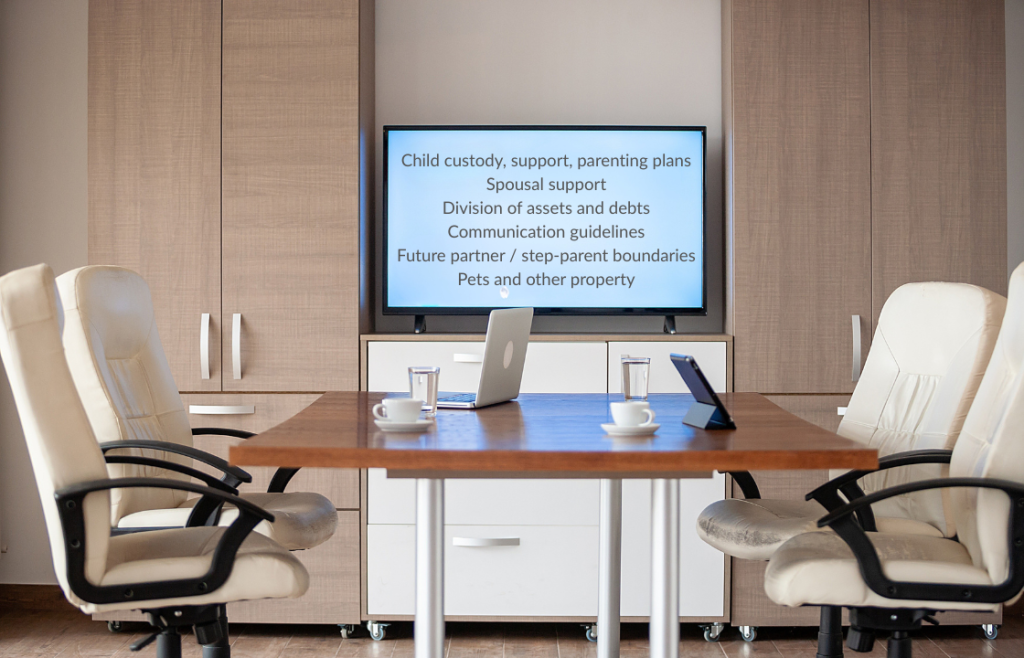 an office scene with white chairs and a table and laptops
