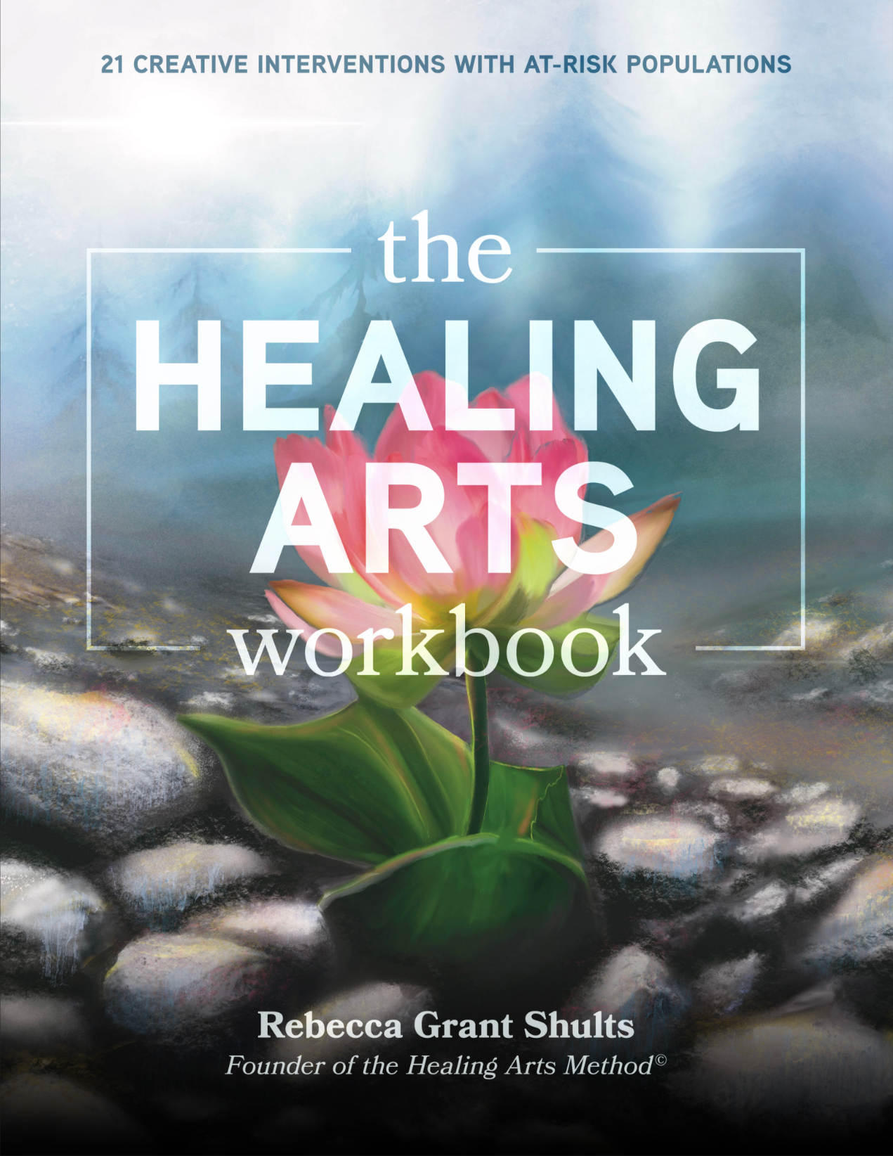 Book cover titled "The Healing Arts Workbook" with a pink lotus flower growing out of a river of rocks and water, with a cloudy sky background.