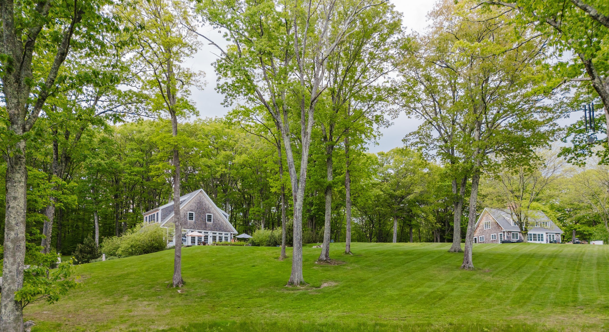 Exterior perspective highlighting the guest house’s location (left) in relation to the owner’s home (right), each with its own surrounding space