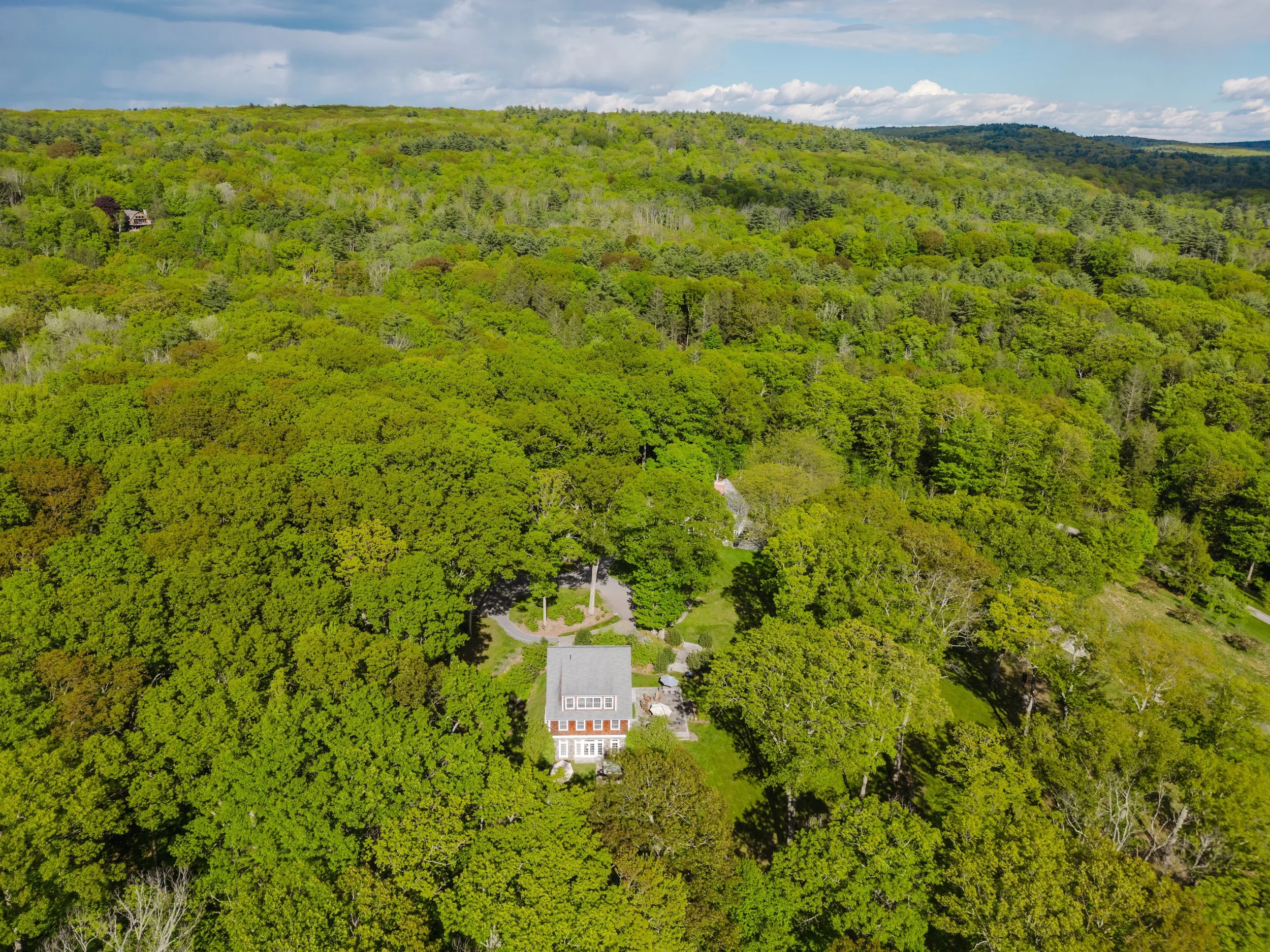Aerial showing home nestled in private forest