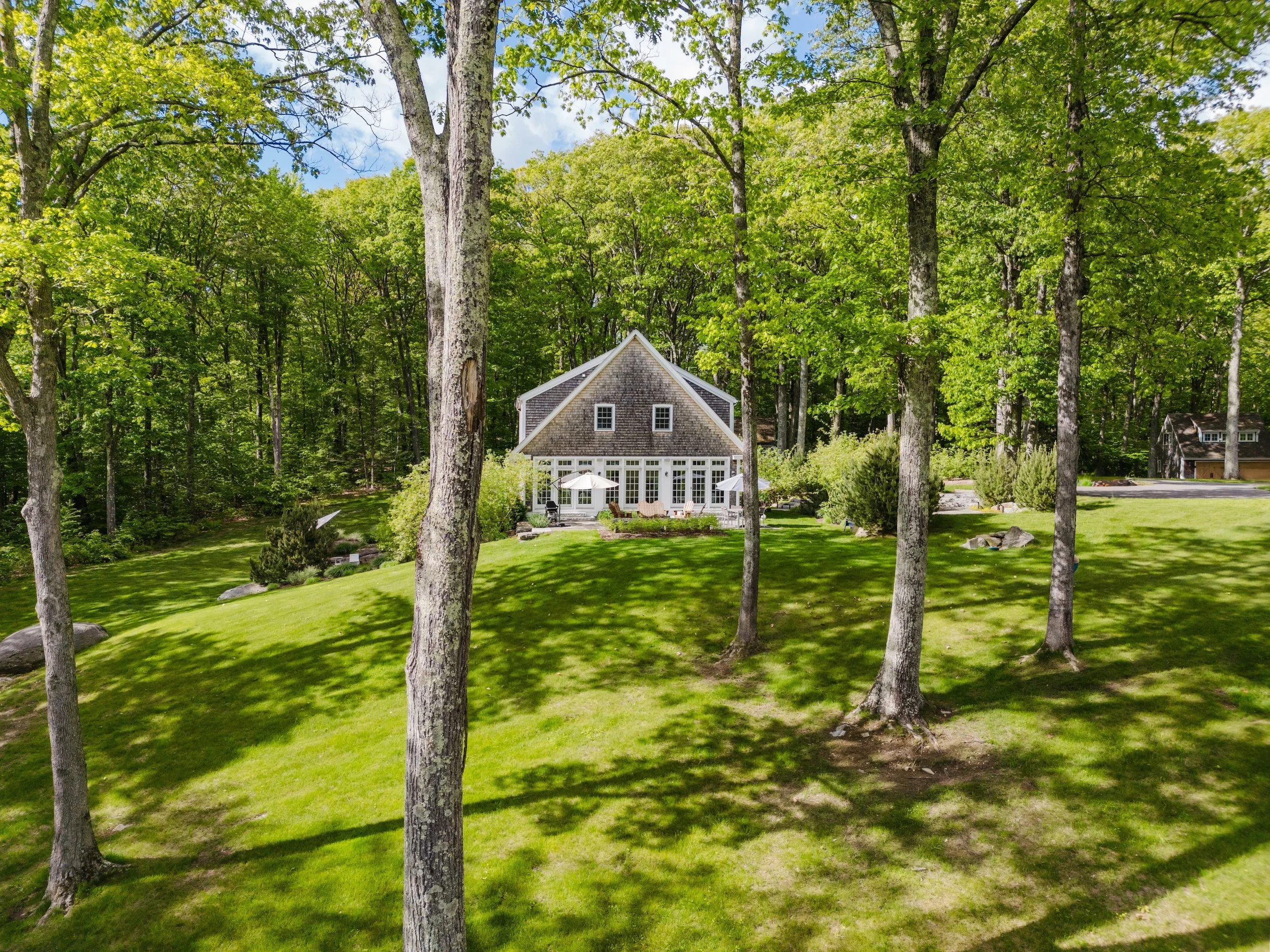 View from wooded yard toward the home