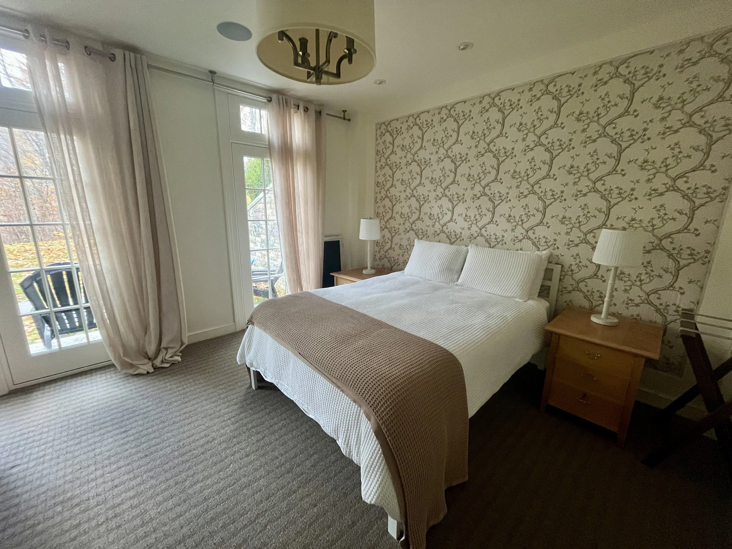 Bedroom 5 with 1 queen bed located on lower level off the gym and bathroom with steam shower and jetted tub