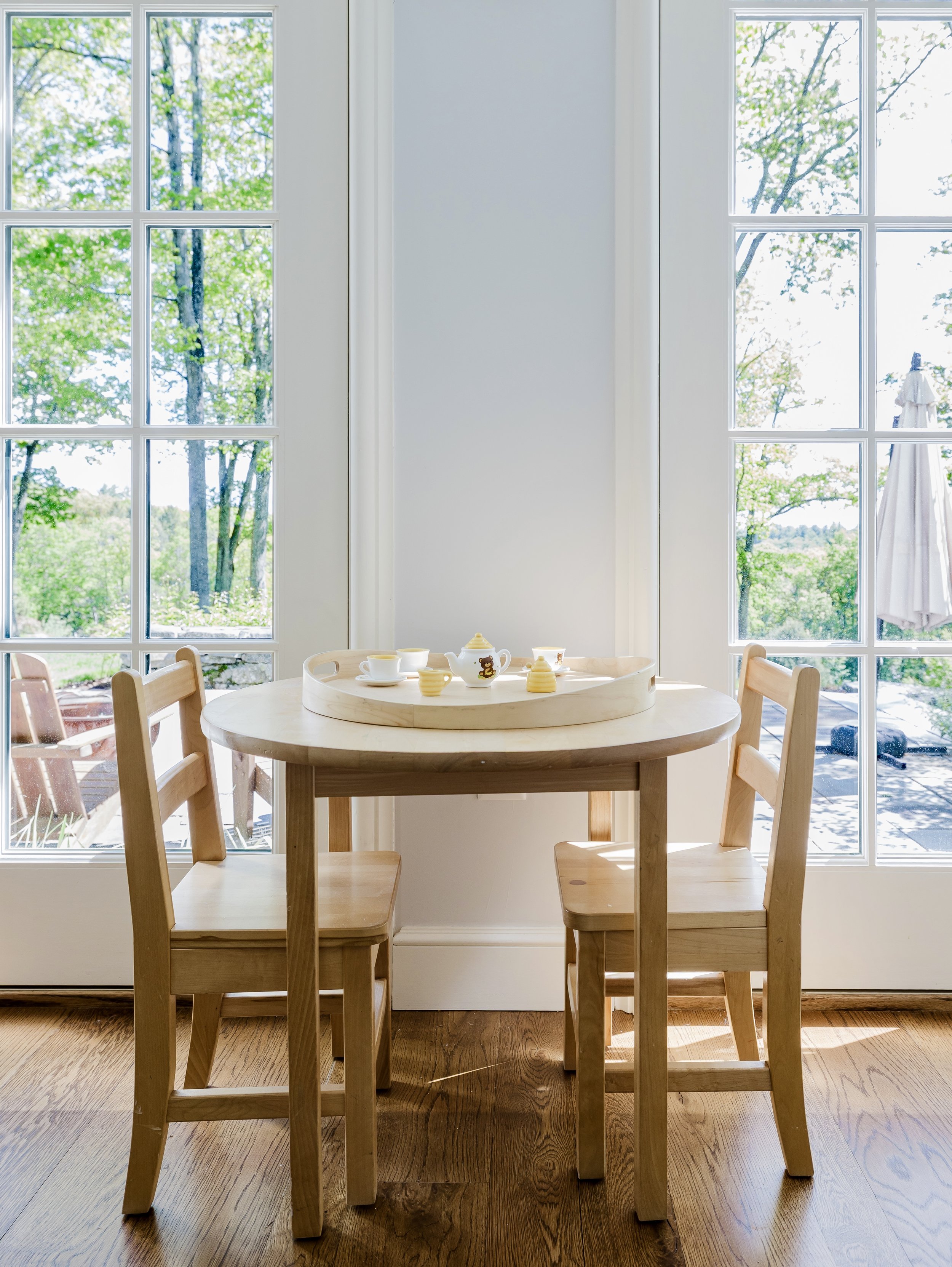 Child-sized table with tea set and patio views