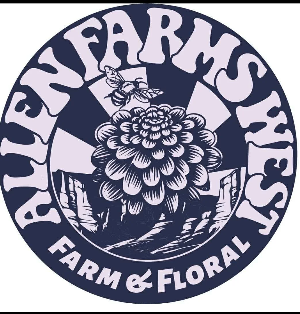 Logo for Ephrata Farm & Floral featuring a bee above a large flower, with mountains in the background, text around the circle