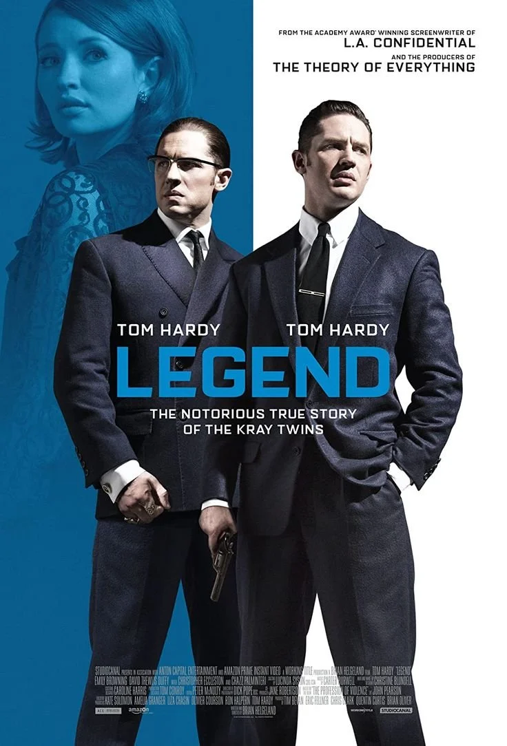 Movie poster for 'Legend' featuring Tom Hardy in two roles as the Kray Twins, with a blue background and a faded image of a woman at the top left. The poster includes text about the film and the actors.