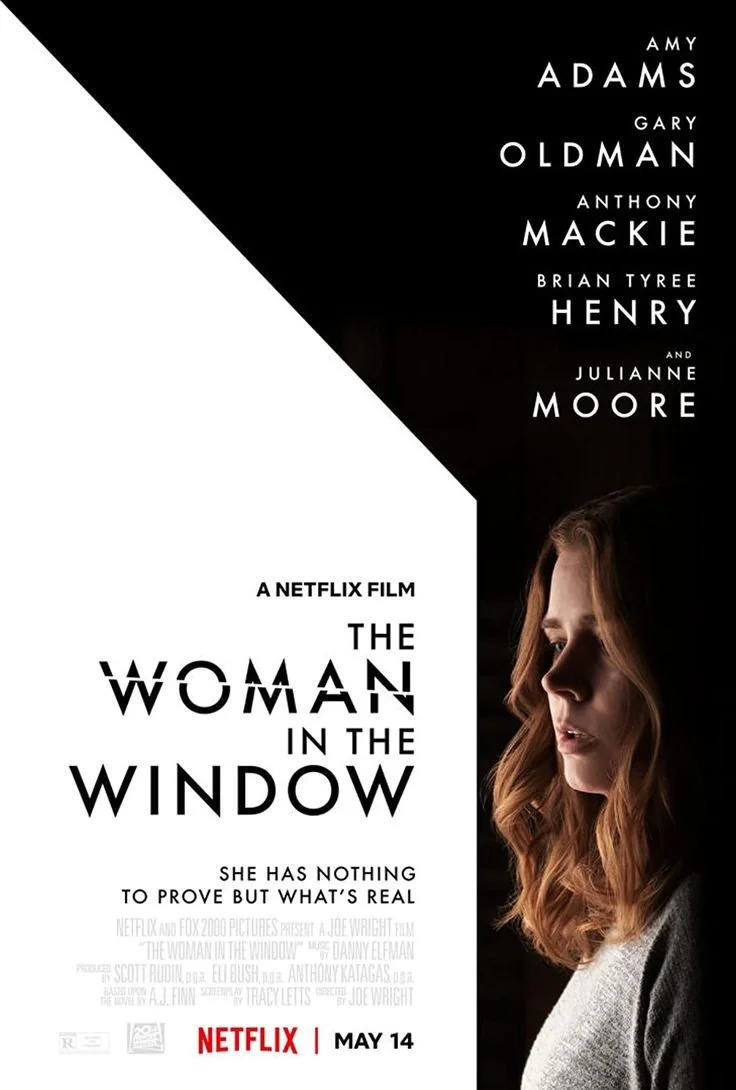 Poster for the Netflix film 'The Woman in the Window' featuring a woman's profile with long, wavy hair, looking to the side, with text listing the main cast and release date of May 14.