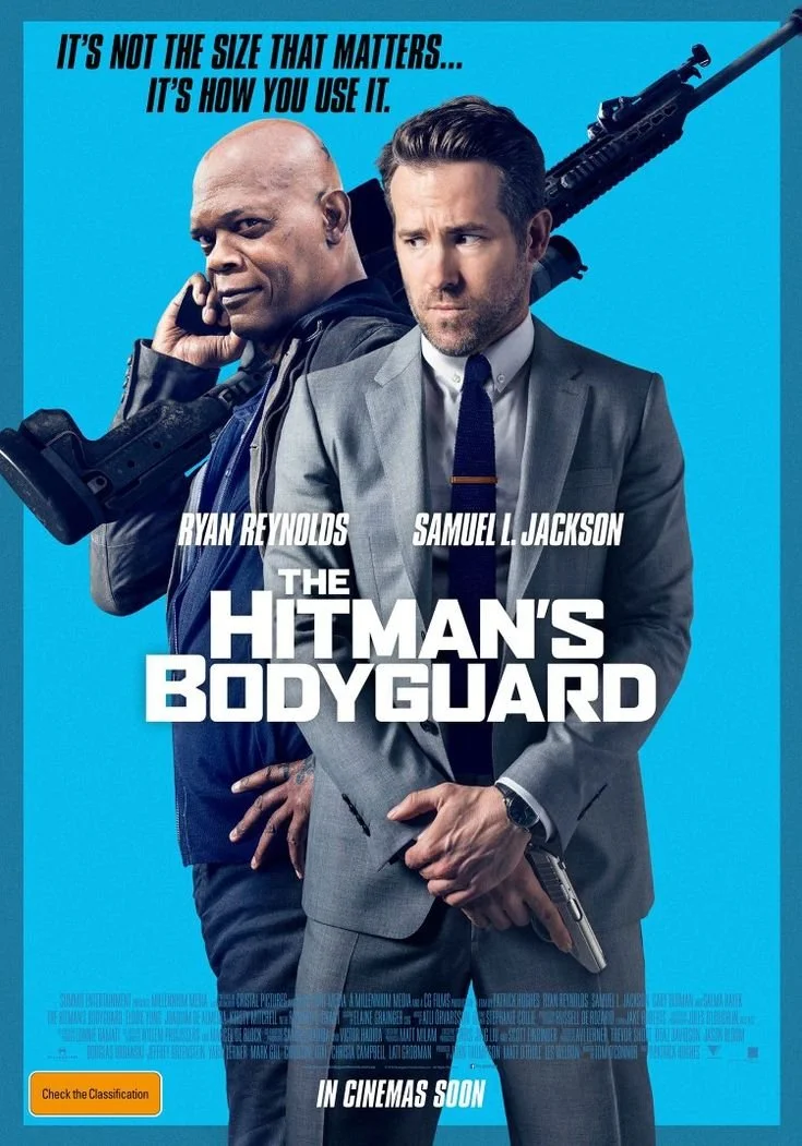 Movie poster for 'The Hitman's Bodyguard' featuring Ryan Reynolds in a suit holding a gun and Samuel L. Jackson in a hoodie holding a phone, with a large rifle on his shoulder, against a blue background. The poster includes the tagline, 'It's not the size that matters... It's how you use it,' and indicates the movie will be in cinemas soon.