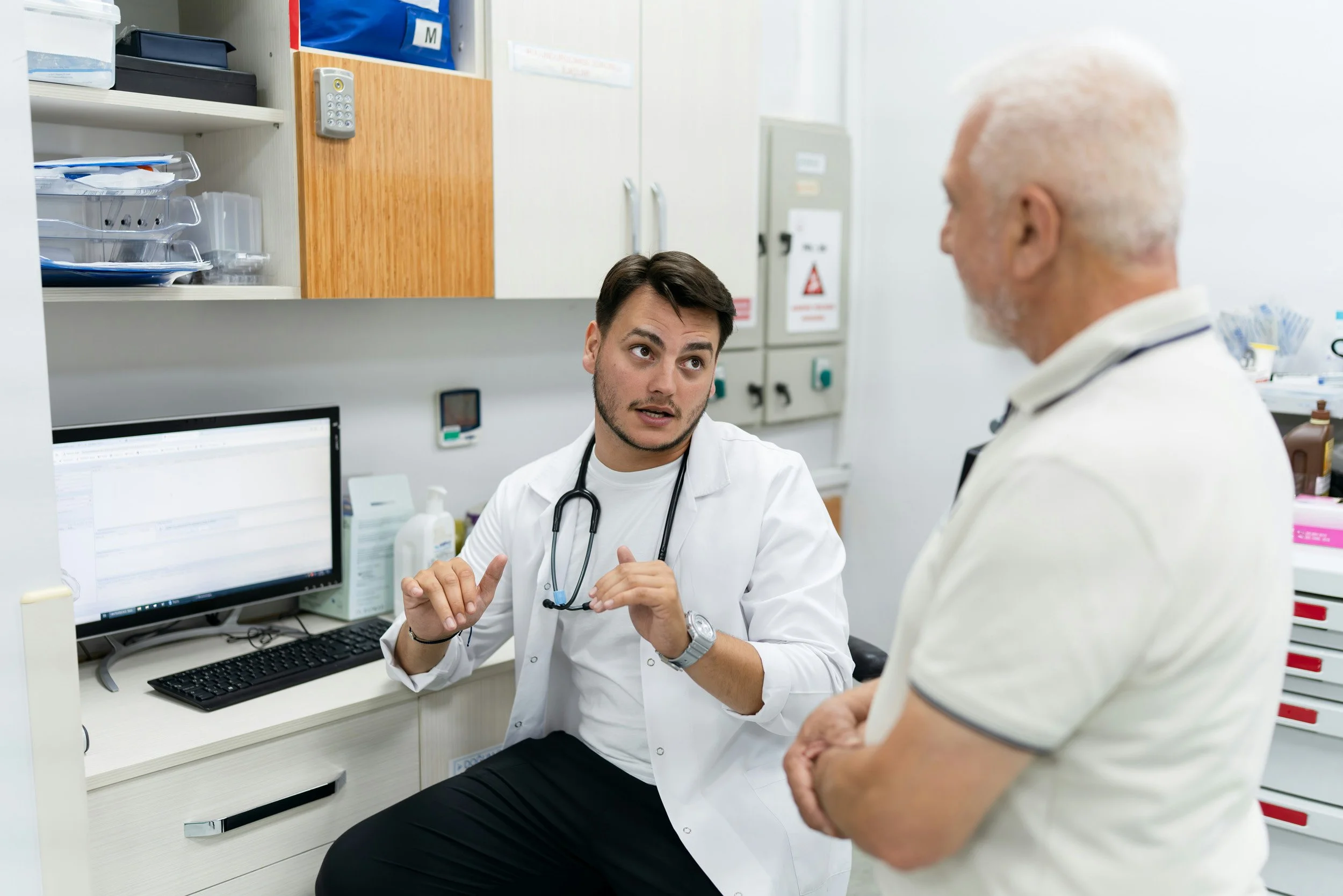 Two physicians discussing patient care in a clinical office.