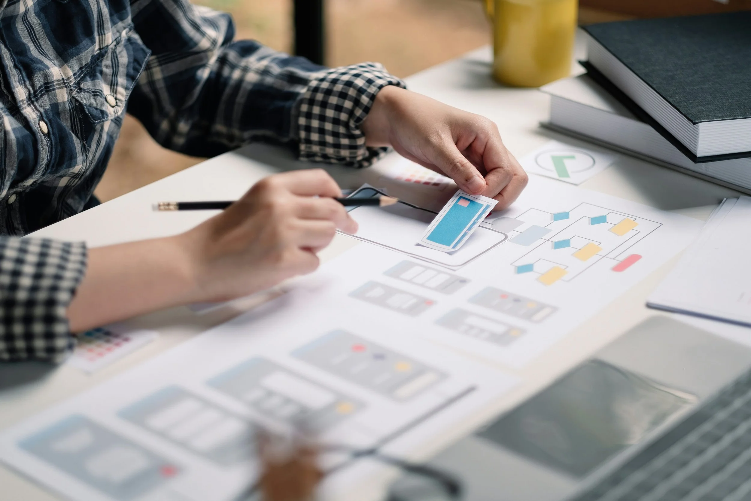 Researcher reviewing mobile app wireframes during digital health design research.