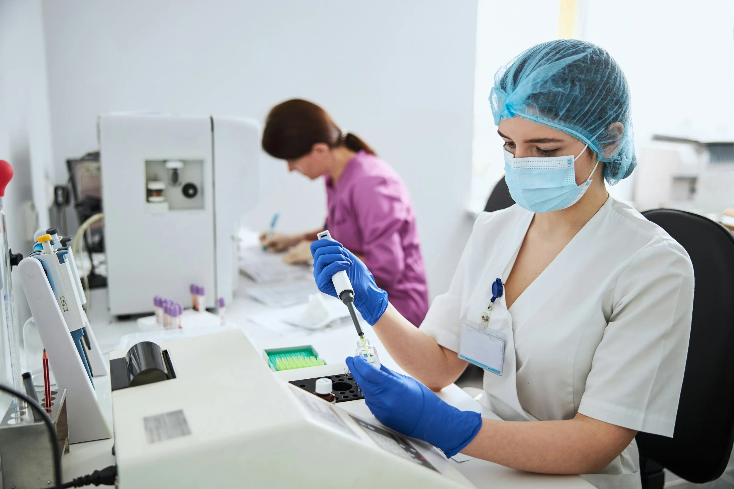 Laboratory technician handling a test sample during medical research.