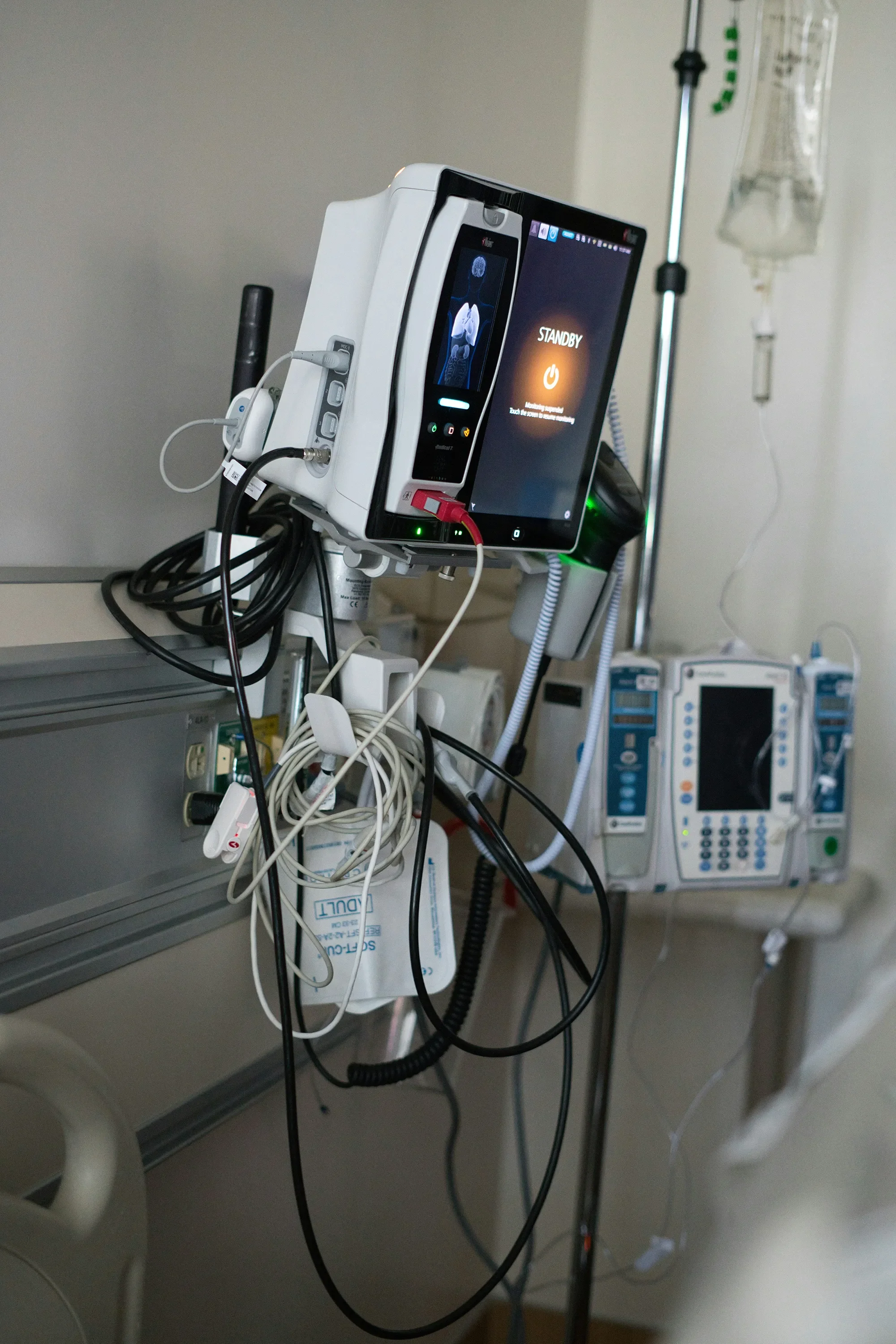 Hospital monitoring equipment and IV drip in a clinical care environment.