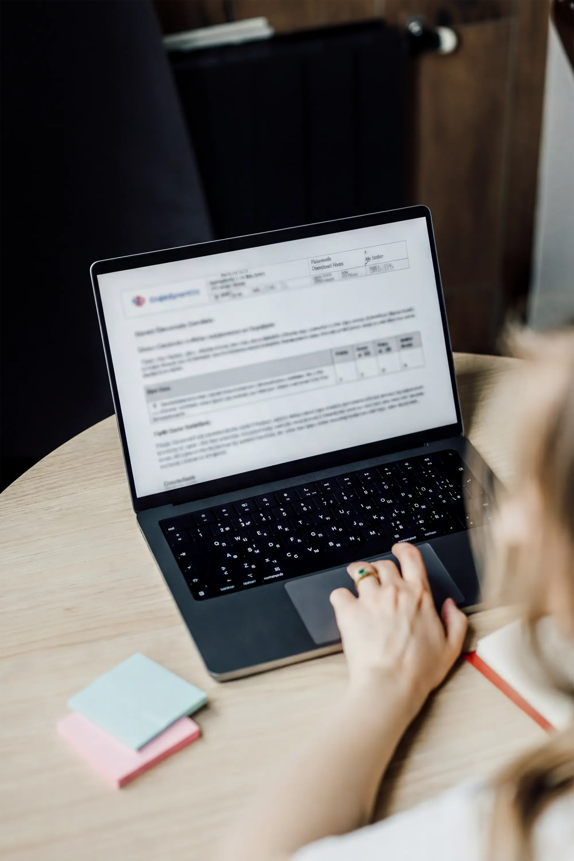 Researcher working on a laptop with design notes during product research.