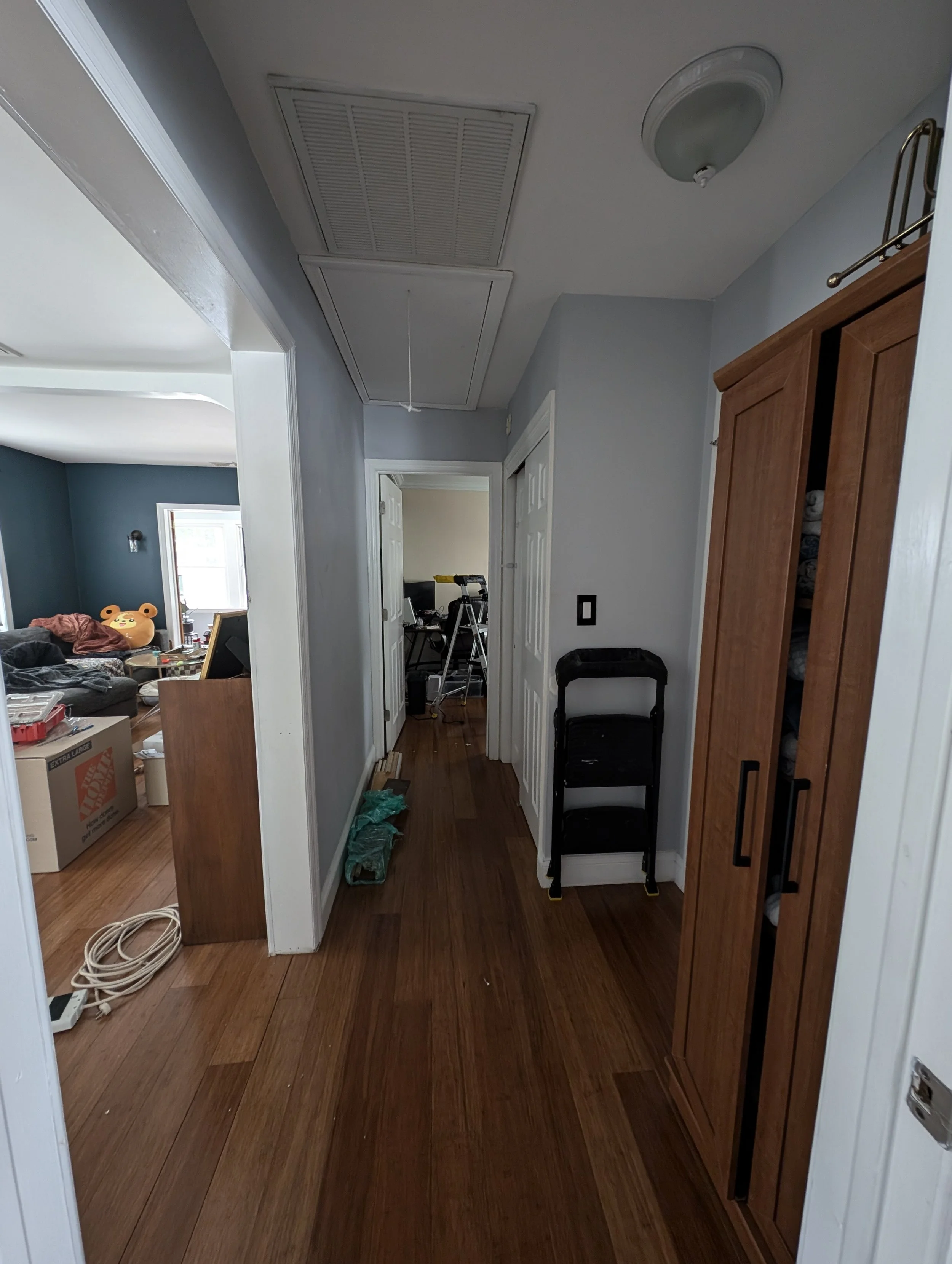 before photo of a small hallway. baby blue color throughout.