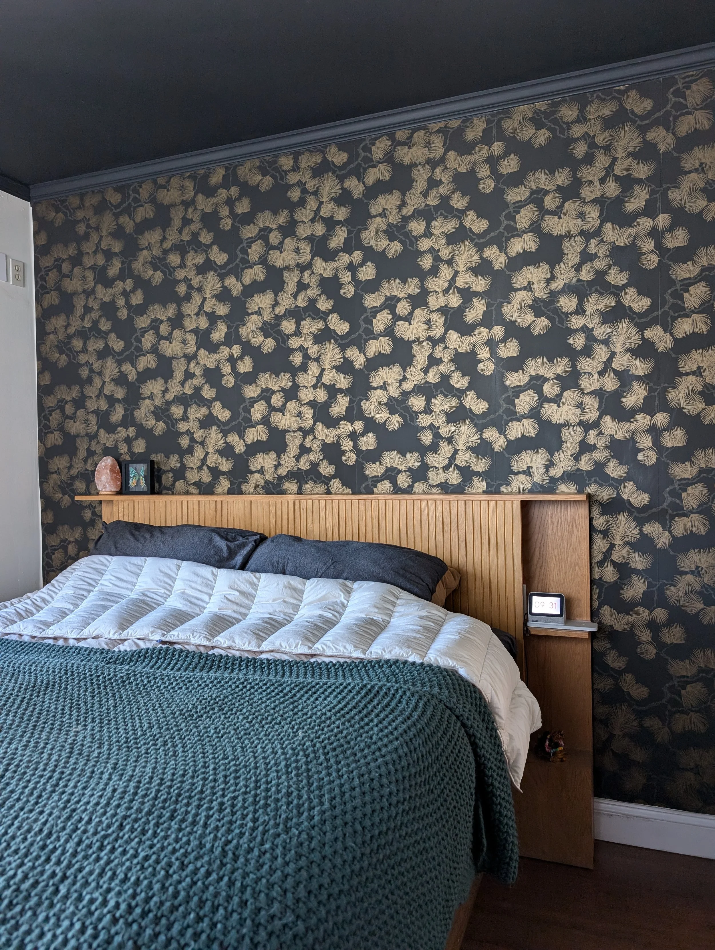 Painted this bedroom's ceiling a dark charcoal, matching crown molding, and installed wallpaper to this accent wall