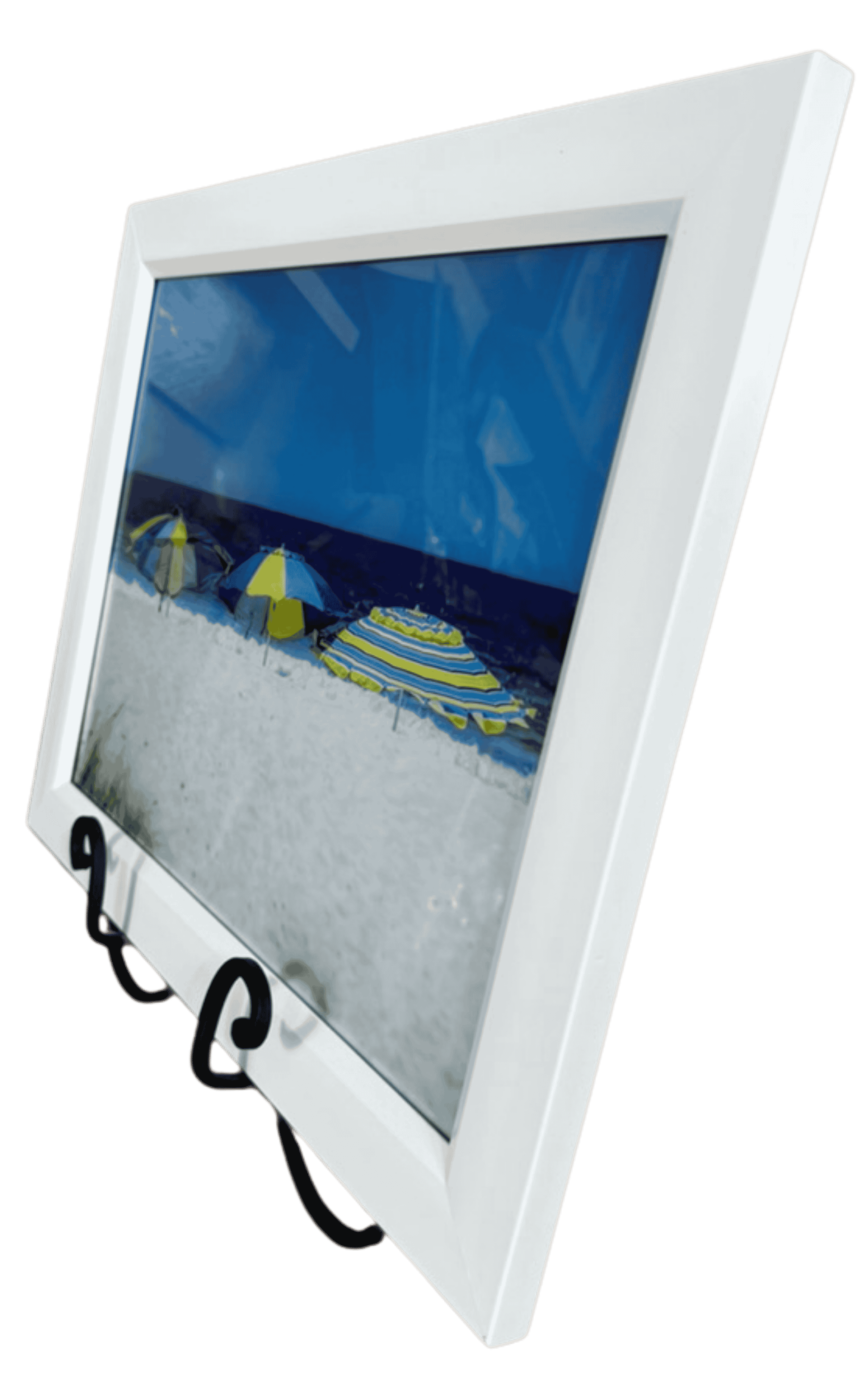 Framed beach photograph with colorful umbrellas on white sand and blue ocean.